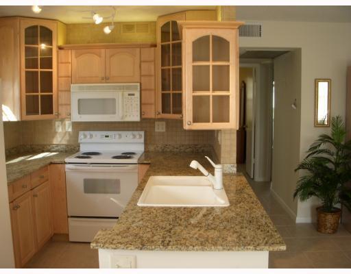 Welcome to this charming two-bedroom, two-bathroom condominium nestled in the Andover Condos community of West Palm Beach, Florida. This two-story residence offers 798 square feet of thoughtfully designed living space, providing comfortable accommodation across multiple levels. The practical layout features two well-appointed bedrooms and two full bathrooms, making efficient use of the available square footage. Located in West Palm Beach, this condo presents a convenient residential opportunity for those seeking a compact yet functional home in an established community setting. Move-in ready 2-bedroom and 2 full baths updated first-floor corner unit.  Park-like rear garden area to enjoy from the screen-enclosed covered patio.  Updated kitchen with well-appointed cabinets and granite counters.  Ceramic tiles throughout the main living area.  Come see this special  home in Century Village.