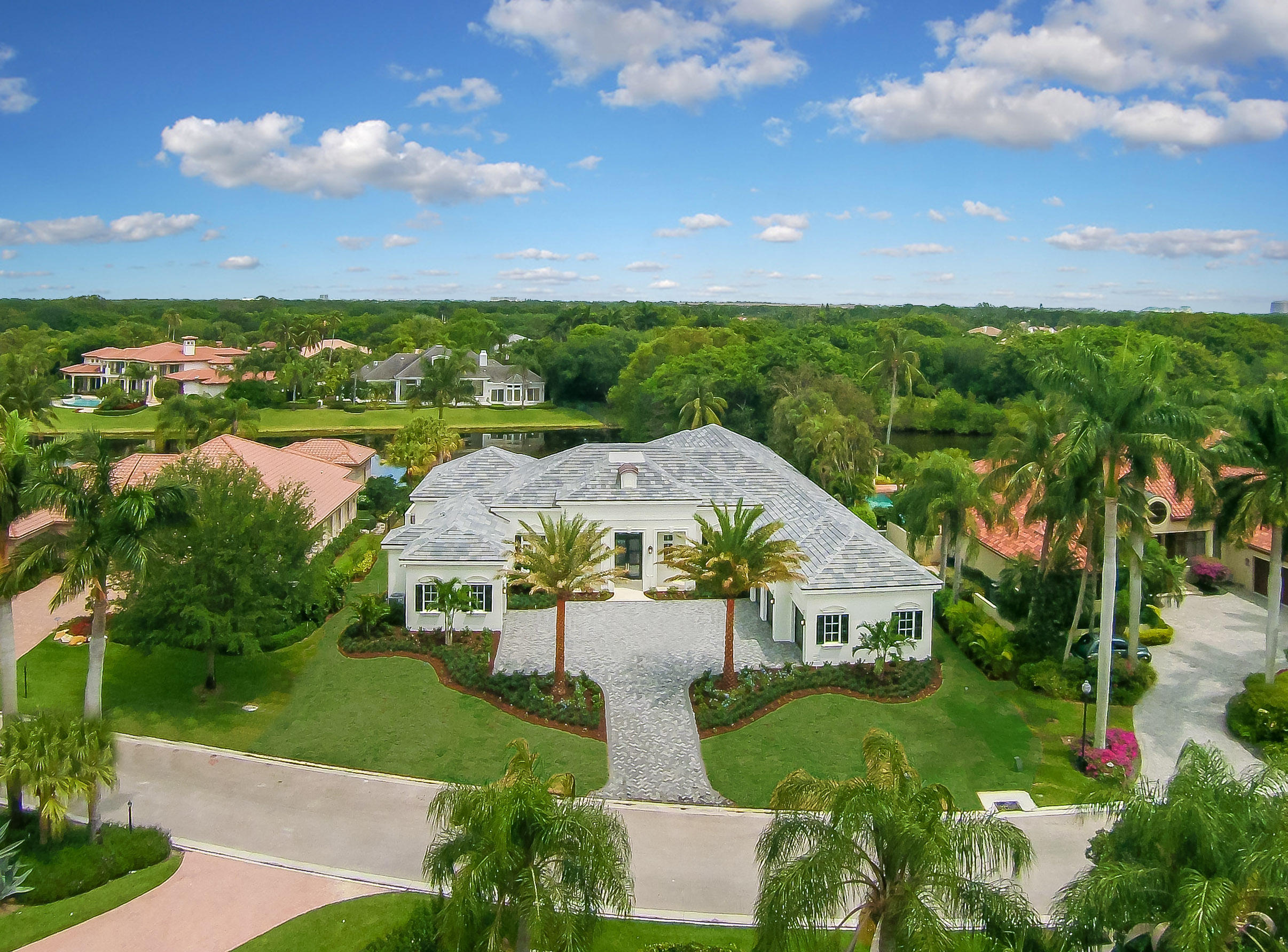 Outstanding custom estate home has four bedrooms, seven bathrooms, a huge master bedroom suite, a large club room and an oversized loggia.  The house is 6,300 square feet of open space with a gourmet kitchen, extraordinary finishes, a three car garage, plus an over sized golf cart garage.  Located on a quiet water lot, it's placement in Frenchman's Creek offers the buyer a rare opportunity to purchase new construction built by Onshore Construction. **furniture seen in home can be purchased for $250,000.