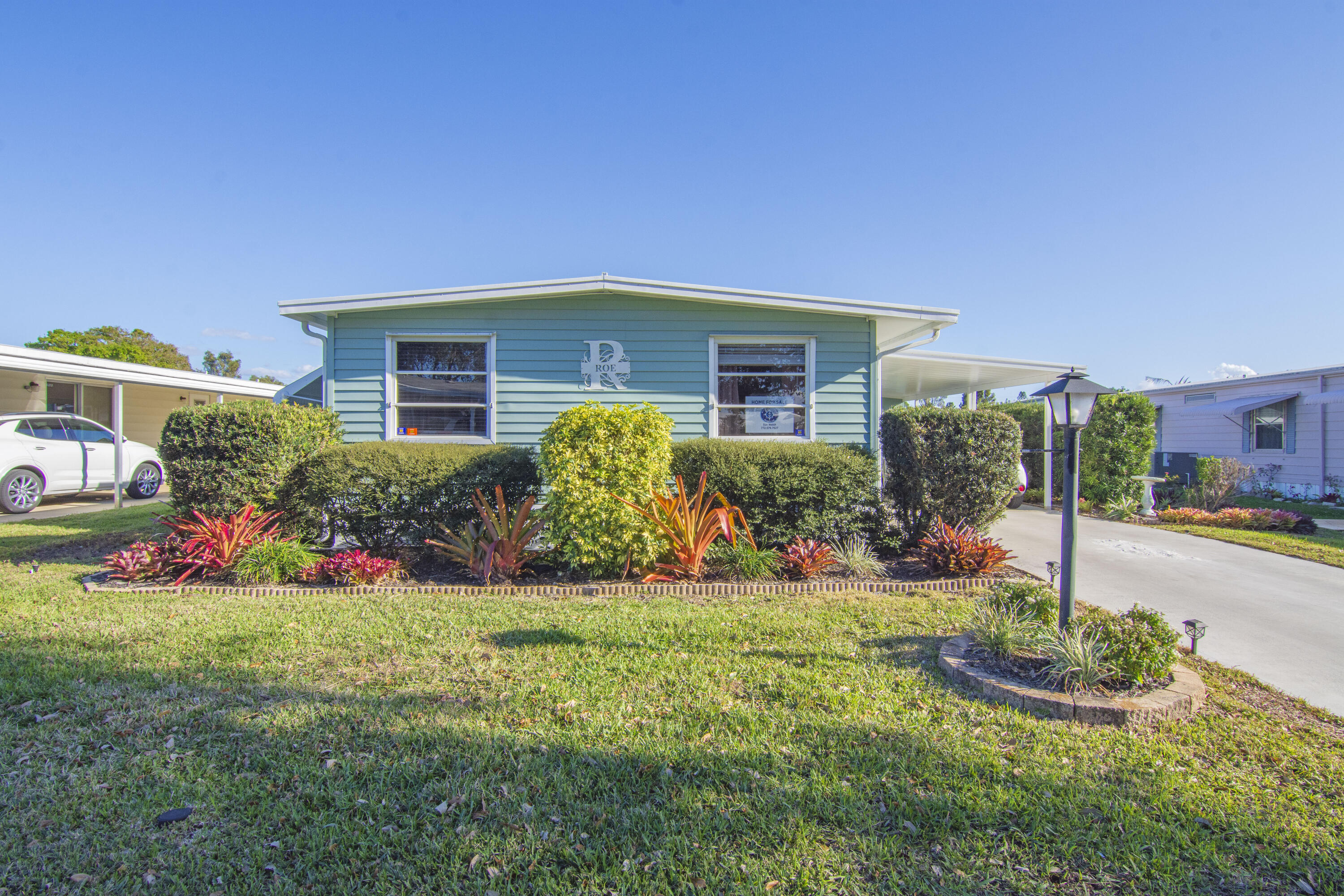 Welcome to the relaxed Florida lifestyle in the highly desirable 55+ community of Pinelake Village, just minutes from the beaches, shopping, dining, and the charm of downtown Jensen Beach. This charming double-wide home features 2-bedrooms, 2-bathrooms, updated flooring, large master bedroom, large walk-in closet, remodeled master bathroom, and a spacious enclosed gathering room at the front of the house perfect for entertaining and/or relaxing.  Roof was sealed in 2025, and new AC Unit was installed in 2018.  Lot rent is $805 per month and includes cable, trash removal, recycling, and all the amenities of the clubhouse.  HOA membership is optional and is only $10 per year, per household. Washer and Dryer do not convey!