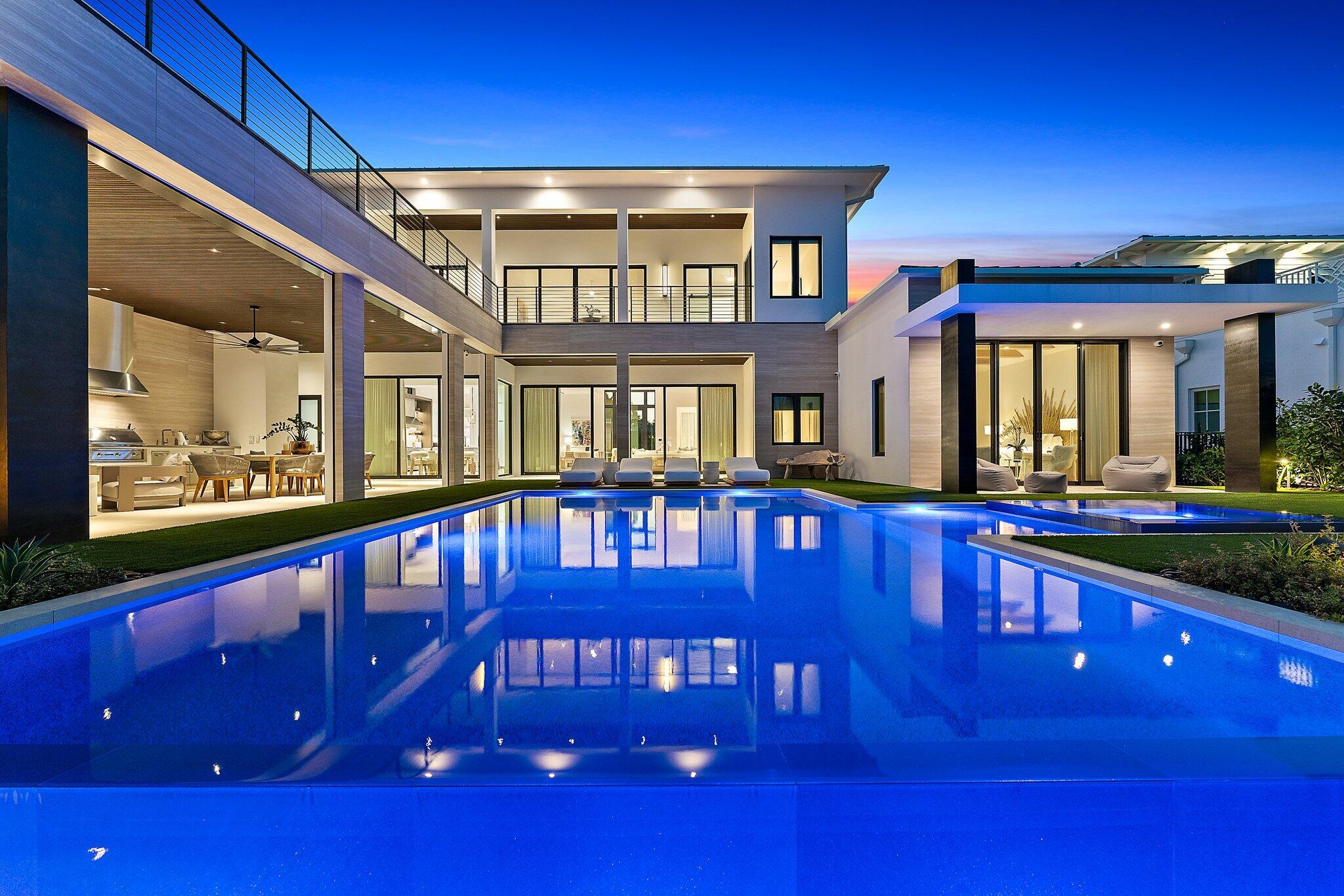 There is a beautiful California vibe in this uniquely styled, brand new construction, directly on the Intracoastal Waterway in a no wake zone, and on one acre, just South of Donald Ross Road.  12 foot ceilings throughout the first floor offer amazing views to the pool, expansive lawn, and deep water.  White Oak floors warm the spaces, and walls of glass windows and doors keep the home light and bright.  The primary suite and one guest suite are on the main floor, and two additional suites, plus a large loft area with wet bar, and den, occupy the second floor.  There are two laundry rooms in the home, three half baths, an elevator, wine room, Savant system, and a three car garage.  Best of all, there is an additional lot included to the West with plans for a three bedroom guest house.