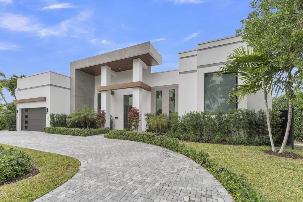 Modern waterfront living awaits in this 2023-built custom residence by Gold Coast Homes, now offered as a resale in the desirable Tropic Isle neighborhood of Delray Beach. Situated on 90 feet of waterfrontage with no fixed bridges, this one-story home offers approximately 3,168 sq ft under air with four bedrooms, four full bathrooms. Features include 14-foot volume ceilings, impact windows and doors, smart home technology, and premium finishes throughout. The chef's kitchen is equipped with a Thermador appliance package. Outdoor living includes an infinity-edge heated pool with spa, & covered patio.