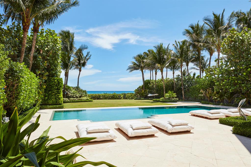 This sensational direct oceanfront property is located in Juno Beach, Florida and has breathtaking views of the Atlantic Ocean from all major rooms, and the pool and spa.   The residence offers 9,188 total square feet with 4 bedrooms, 4 full baths, 1 half bath, and an air-conditioned 3-car garage.  The home features an open floor plan with large hurricane impact windows and French doors which take full advantage of the spectacular ocean views.  The light and bright interiors have high ceilings, exceptional millwork throughout, wood flooring, spacious rooms, and top-of-the-line appliances.  The living room has a double height ceiling, a gas fireplace and views of the water. The eat-in kitchen is equipped with a large Sub Zero refrigerator and freezer, a Wolf gas range with double ovens, a 50 bottle wine fridge, Miele microwave, Miele coffee machine with a cup warming drawer, ample storage, ocean views, and much more.  
The home offers a seamless transition from indoors to out.  The first floor has doors opening out to the pool terrace and the large covered loggia.  The loggia is perfect for dining, lounging, and entertaining al fresco complete with a fireplace, a summer kitchen, as well as a spiral staircase that leads to a large open terrace upstairs.  The upstairs terrace offers elevated views of the pool and ocean beyond and can also be accessed from the master and guest suites. 
The master suite has direct ocean views from the bedroom and bath. The bedroom features a sitting area, doors to the outdoor terrace, wet bar, and a large walk-in closet. The master bath has a jacuzzi tub, dual vanities, dual water closets (one with bidet), and dual showers (one a steam shower).  The guest suite, in addition to the water views and access to the upstairs terrace, has a large walk-in closet, a breakfast bar, and a wonderful bathroom with a jacuzzi tub, separate shower, and water closet. 
Additional features include a library, powder room, two bedrooms on the first floor each with ensuite baths and walk-in closets, an elevator, a full house generator, a large storage room, laundry room, HVAC system, gated entry, an extensive video surveillance system, and an indoor/outdoor audio system.