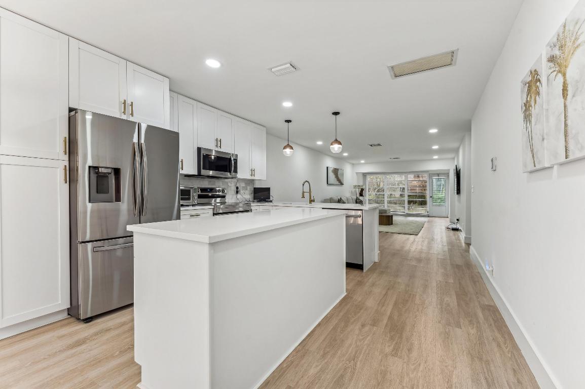 Contemporary and beautifully renovated, this well-located and spacious 2 bedroom and 2 bath at Palm Greens is a must see! Brand-new from the floors to ceilings. Bright and open-concept kitchen with double island, pantry, and plenty of storage. All new stainless steel appliances including brand new water heater. Both bathrooms with modern vanities, frameless showers and neutral color tones. The master bathroom features a double vanity and two walk in closets. Enjoy the privacy of a large paved patio plus screened in patio. This corner unit is very private with a large green space in the backyard. Park directly in front. Palm Greens is a fabulous, active 55+ community, including Tennis, pool, Clubhouse, and lots of activities. Motivated Seller!