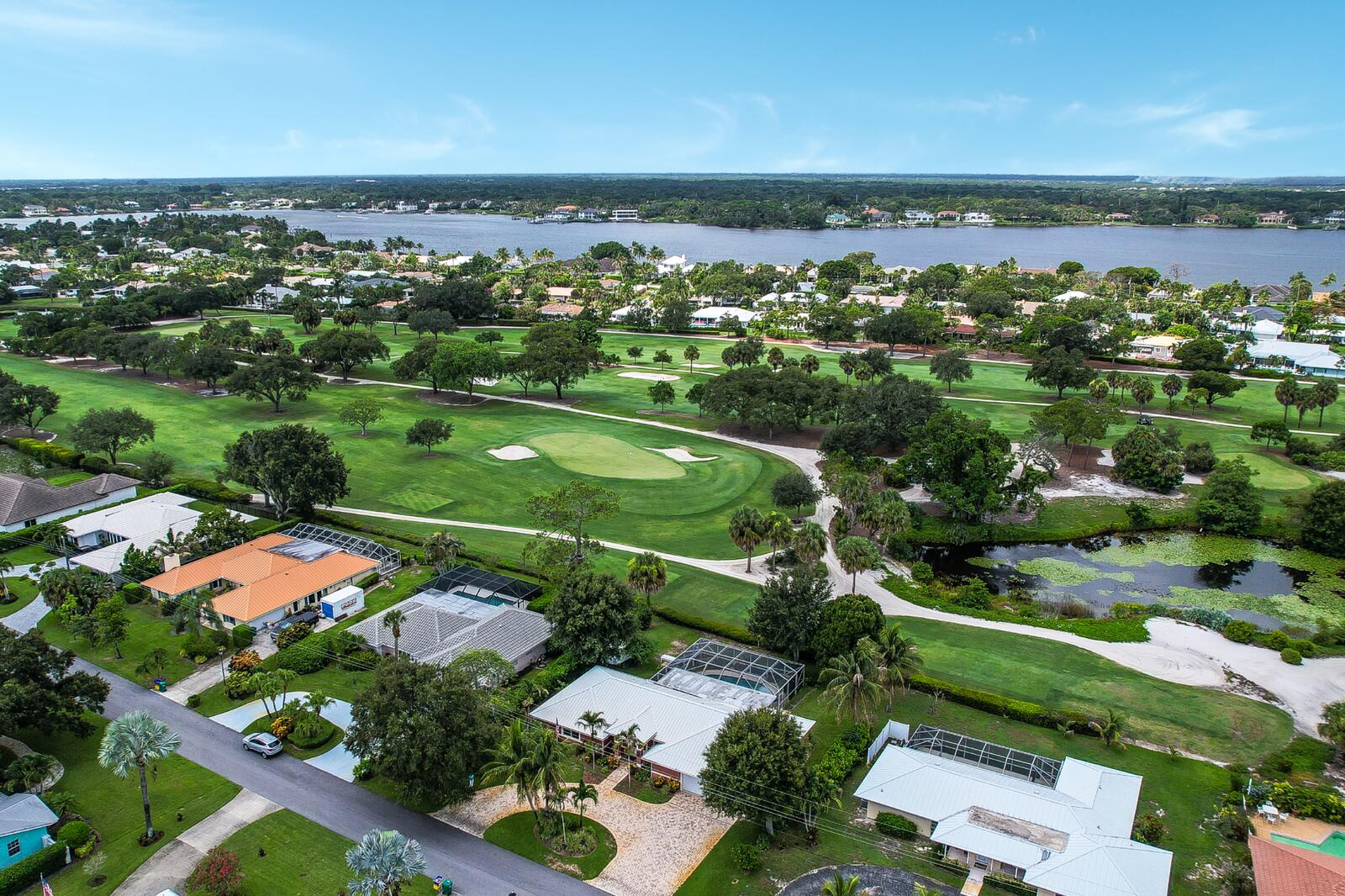 Welcome to Tequesta Country Club, where golf course living meets relaxed coastal living. This one-story CBS home offers 3 bedrooms, 3 bathrooms, and endless potential to update, renovate, or create your dream home. The spacious screened-in pool overlooks the golf course, providing sweeping fairway views and the perfect setting for entertaining or relaxing in your own private backyard oasis.  Thoughtful updates include a metal roof(2006), hurricane-impact windows and doors throughout most of the home(2006), a 200-amp Cutler-Hammer electrical service, a new 5-ton A/C system (2024), updated kitchen appliances (2024), a 2016 water heater, and a hurricane-rated garage door. The oversized two-car garage offers extended storage space. Just minutes from pristine beaches, championship golf, waterfront dining, boutique shopping, and the charming Village of Tequesta, this home offers the perfect blend of comfort, convenience, and the South Florida lifestyle.