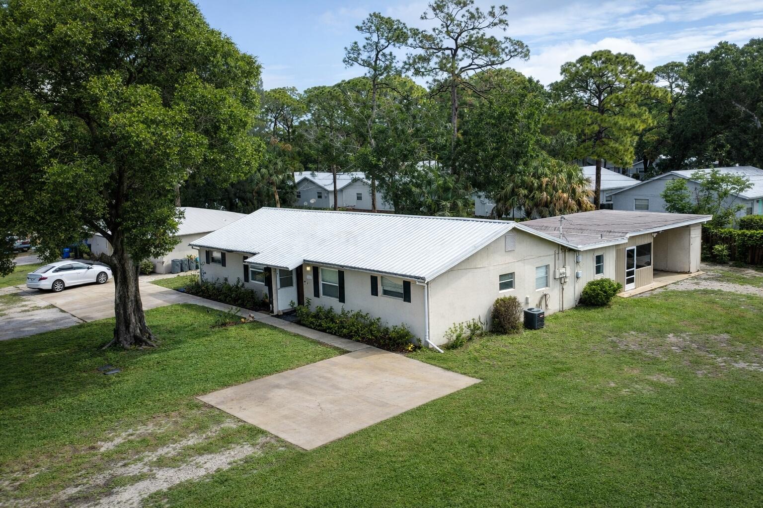 Why choose between a home and an investment when you can have both? This updated Vero Beach duplex at 1504-1506 41st Avenue is perfect for house hacking. Live in the vacant 3BR/2BA at 1504, move-in ready with a beautifully updated bath, while the renovated 2BR/1BA at 1506 generates $1,600/month on a flexible month-to-month lease. That unit features granite countertops, solid wood shaker cabinets, tile bath, enclosed Florida room, and fenced yard. A newer metal roof, separate utilities, screened porch, carport with utility sink, large shed, and extra storage add everyday convenience. Quietly set by a dead-end street yet close to shopping, dining, schools, and major routes. Neighboring duplex also available.