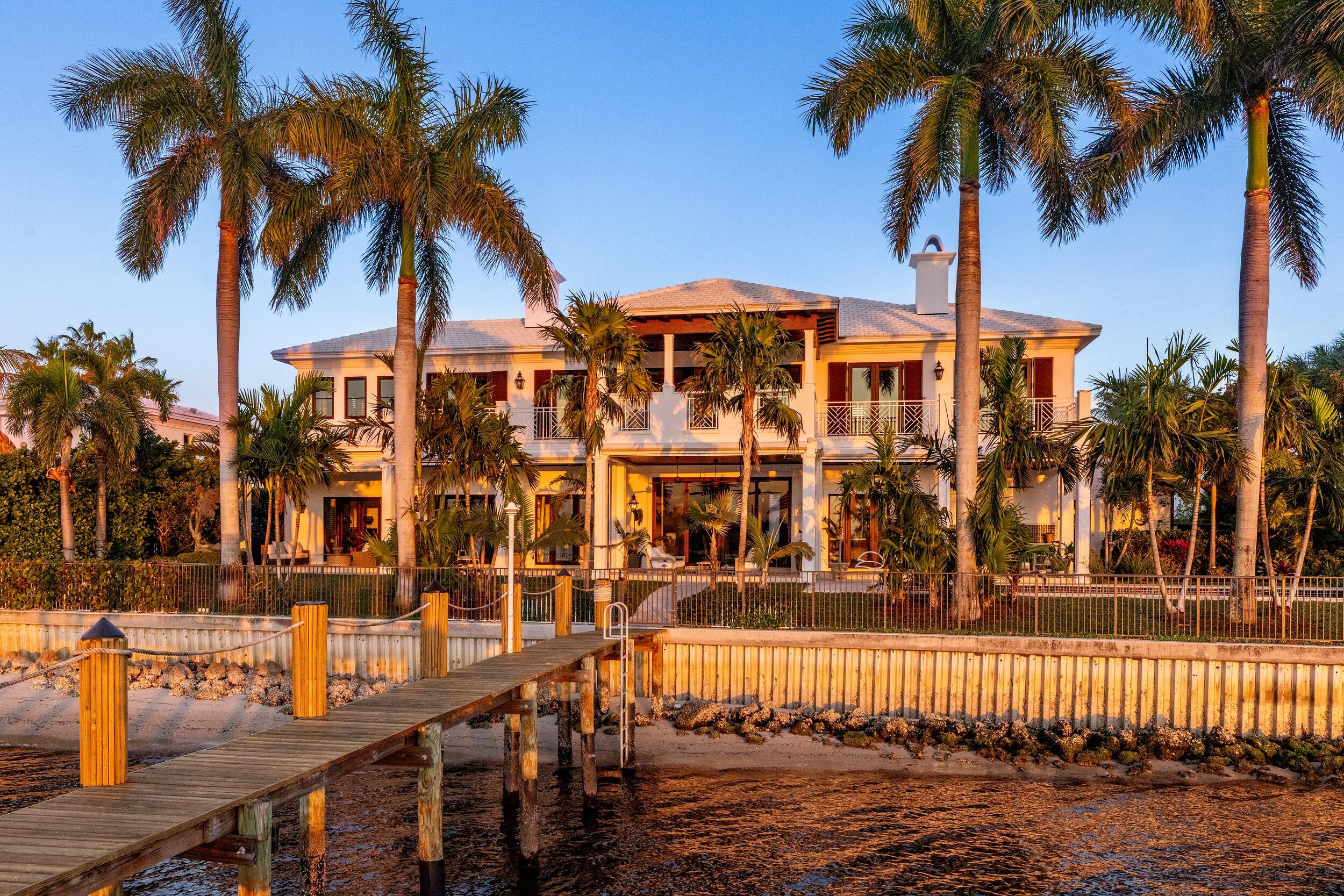 Stunning British Colonial estate in serene Point Manalapan. This elegant and inviting 5BR/5.2BA home is situated on a fantastic, lakefront lot and features breathtaking views of the Intracoastal. Gracious floorplan with welcoming, double height reception room, formal dining room, and spacious great room. Gourmet kitchen with large island, top-of-the-line appliances, and butler's pantry. Expansive primary wing complete with sitting area, dual walk-in closets, large bath with dual vanities, and fabulous covered balcony with stunning water views. Gorgeous outdoor spaces with covered loggia that spans the entire back of the home, summer kitchen, pool with spa, and lush tropical landscaping giving the home a relaxing, resort-style feel. Recently renovated boat dock with two lifts, including a 30,000lb primary lift, and direct ocean access through the Boynton Beach inlet, perfect for the avid boater. Additional highlights include elevator, first and second floor laundry rooms, upstairs living area, and 3-car garage. Recently installed new whole house WiFi and Sonos systems, and numerous other improvements. Point Manalapan is a unique community, featuring both a 24/7 guard gate operated under the Manalapan Police Department, and a no-wait, no-fees membership to the La Coquille Club, which is part of the luxurious and beautifully upgraded Eau Palm Beach hotel.