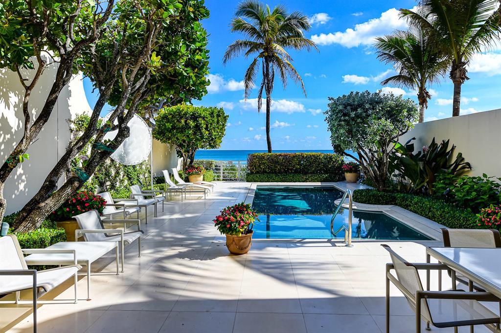 Rare Direct Oceanfront Offering with jaw dropping views. 5,700'+/- exquisitely designed townhouse with the finest custom finishes and interior appointments throughout. Skylights create a profusion of natural light & airy space. A Gracious Master Suite boasts impressively large dual dressing rooms and baths. There are several rooms that can be personalized for guests, media, fitness, office, and staff. Soaring ceiling heights on both levels, elevator, private pool and beach access, full house generator, abundant storage, and a 2 car garage. Pocketed impact glass doors showcase the breathtaking ocean views beyond. The Residences at Sloan's Curve is a private gated enclave that offers the amenities of a 5 star resort with all the conveniences of living in a A+ managed community. A must see!