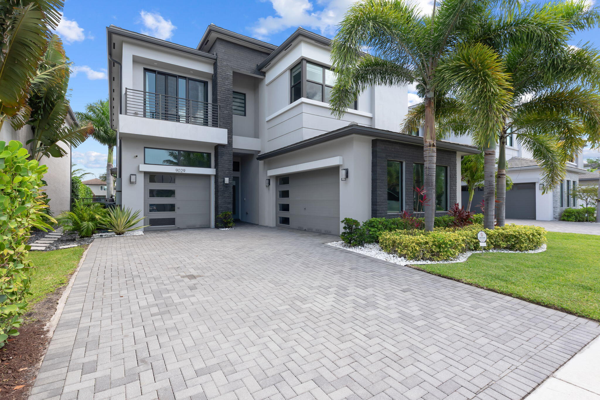 Welcome to the epitome of modern luxury living in the highly coveted community of Boca Bridges. Built in 2021, this spectacular "Florence Contemporary" model at 9029 Dulcetto Court offers nearly 4,000 square feet of impeccably designed living space, where natural light floods through gorgeous high-end finishes. The expansive floor plan features four bedrooms, a massive versatile loft, and a dedicated media room perfect for movie nights. A true sanctuary, the primary suite uniquely boasts two separate bathrooms, complemented by four additional full baths and two half baths throughout the home. Complete with a split two-car and one-car garage design, every detail of this elegant residence has been crafted for the discerning homeowner.   The interior luxury transitions seamlessly to a private outdoor paradise, featuring a large, sparkling pool, a generous covered patio, and a fully screened-in backyard overlooking serene lake views. This resort-style oasis offers the perfect backdrop for grand entertaining or peaceful relaxation. Beyond the property, residents immerse themselves in a five-star lifestyle centered around a magnificent 27,000-square-foot clubhouse, complete with a gourmet restaurant, sports courts, luxurious spa amenities, resort pools, and so much more! This is more than just a home; it is an invitation to experience an elite, world-class lifestyle in Boca Raton.