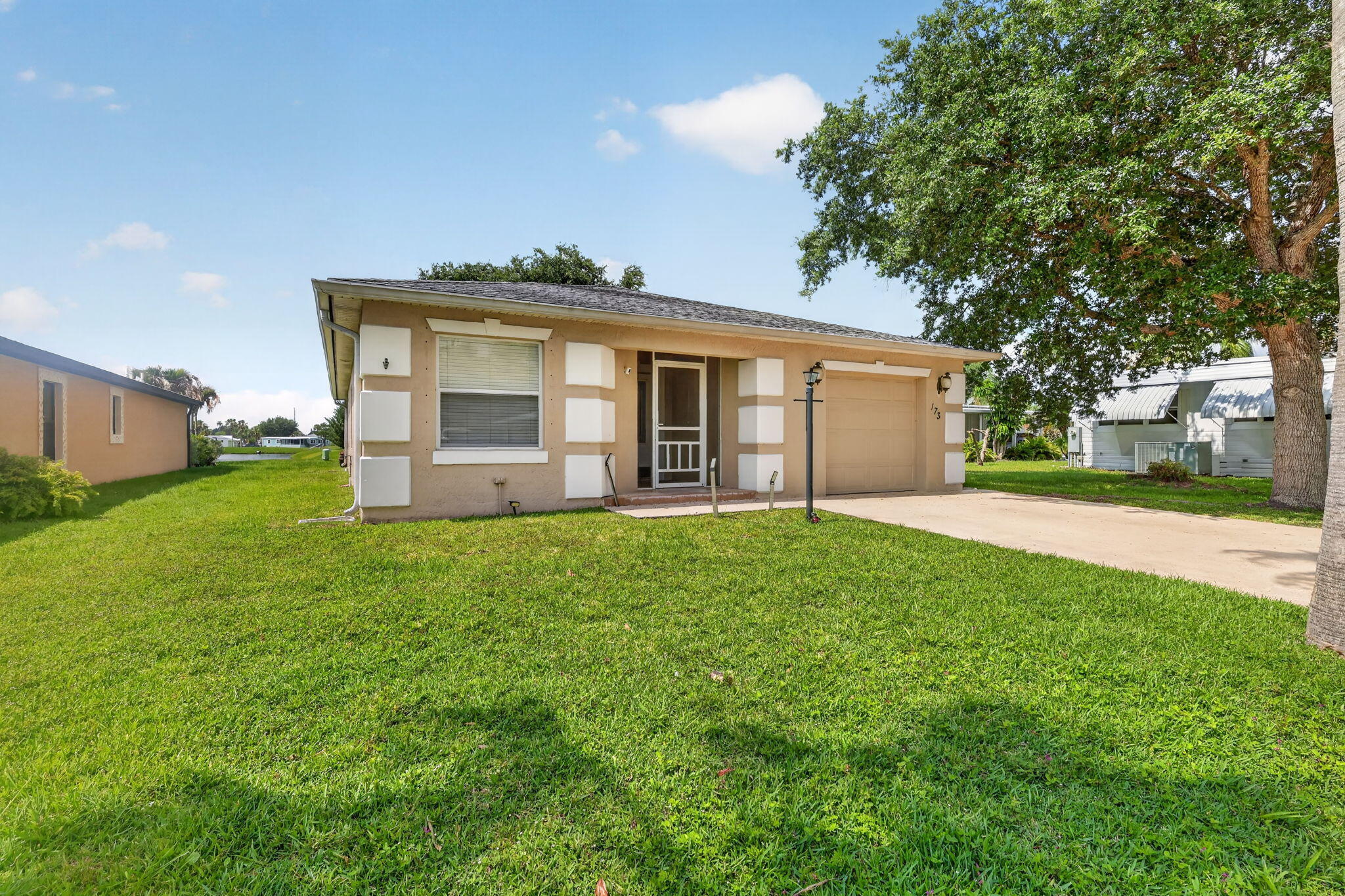 LAKEFRONT 2bed/2bath home w/ stunning REMODELED KITCHEN. Enjoy spectacular LAKE views outside then Step inside & it gets better w/ fully enclosed Florida Rm full of natural light. Modern lighting fixtures & ceiling fans throughout. Open, Spacious Floor plan. Master includes ensuite & oversized walk-in closet. PRIME LOCATION in 55+ comm., near clubhouse & amenities, hospital, postal, grocery, mall, beach & more! Lot lease 786.94 includes FREE GOLF, 2 heatedpools, bingo,pickleball, tennis, workshop, shuffleboard, bocce ,gym, library, outings, 100s of clubs, security, trash, lawn & more! Owner occupied