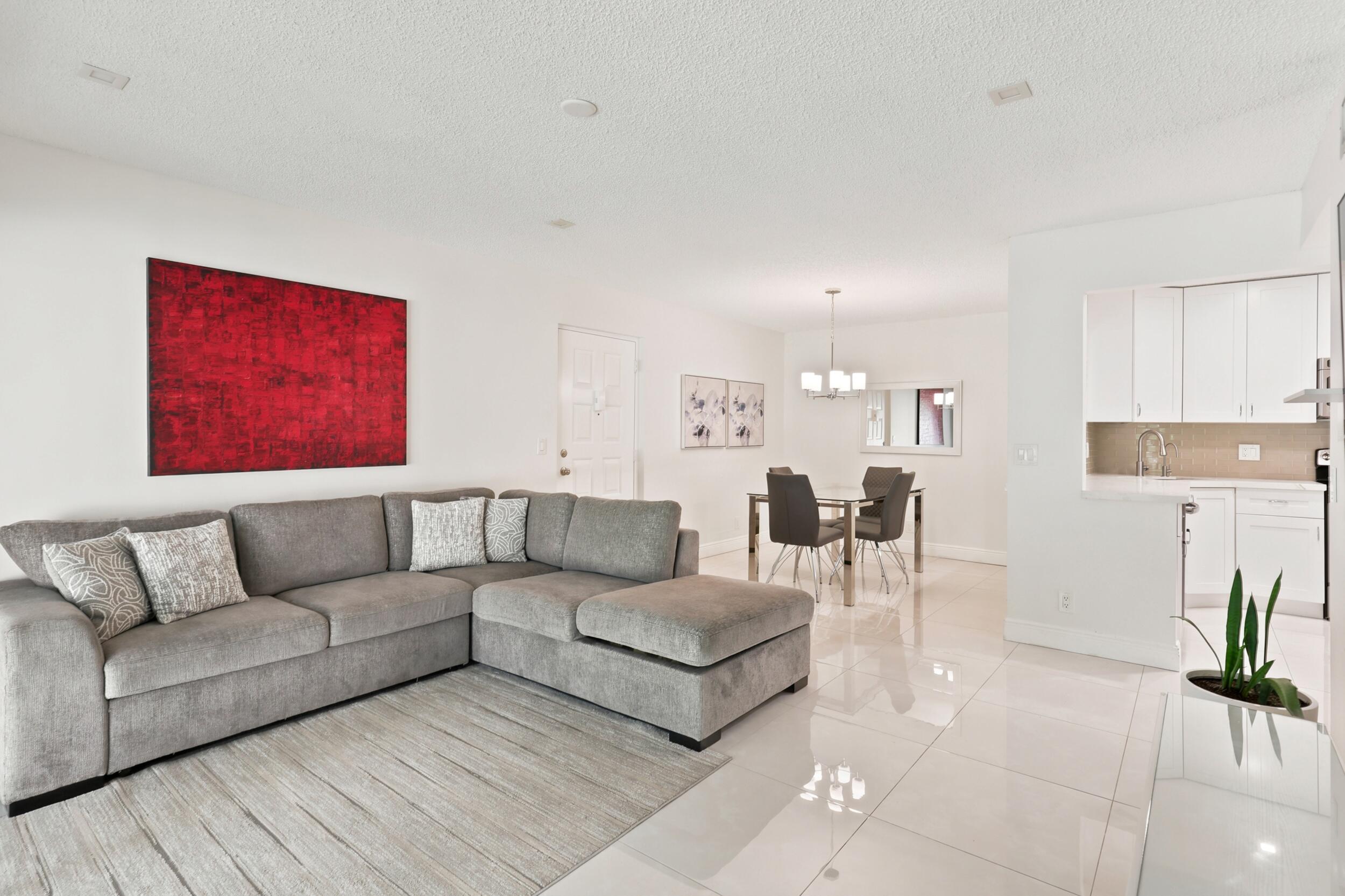 Enjoy beautiful lake views and peaceful sunsets from your private balcony and both bedrooms in this beautifully updated 2-bedroom, 2-bath condo. This bright and well-maintained home features a clean modern look, tile flooring throughout the main living areas, a spacious living and dining area, walk-in closet, exterior storage, and hurricane accordion shutters for added peace of mind.  The kitchen has been tastefully updated with white cabinetry, elegant countertops, stainless steel appliances, and a new refrigerator. The A/C fan is also new, and the building has a new roof installed in 2024.  Located in a pristine all-ages community, residents enjoy great amenities including a pool, pickleball, clubhouse, bocce ball, and shuffleboard.