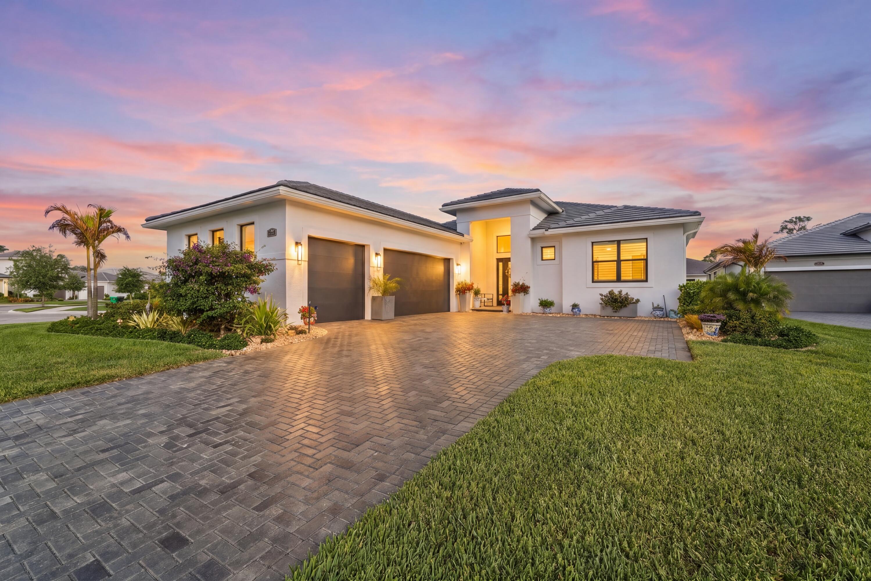 This luxury single family Florida home is thoughtfully designed for both peace of mind and buyers looking for high end finishes and functionality. Key features include impact windows and doors, whole house generator, Rinnai water heater, a saltwater pool with sun shelf, and a 3 car garage, providing security, comfort, and resort style living. Exterior upgrades include sealed paver driveway, pool and lanai, full home gutters, ADT exterior security cameras, and a metal fenced backyard with two gates. The pool is pre wired for a heater, and the lake fed sprinkler system supports efficient irrigation. HVAC is professionally serviced every six months.  Inside, the home offers 24" tile flooring throughout the main living areas and owner's suite, with upgraded carpet in secondary bedrooms. The foyer features a wood inlay ceiling with pendant lighting, setting a refined tone upon entry. The laundry room includes 42" cabinets, quartz countertops, and washer and dryer, ideal for full time or seasonal living. The three car garage is enhanced with epoxy flooring, built in cabinetry, attic storage decking, two dehumidifiers, and automatic garage door openers, making it ideal for vehicle storage, hobbies, or extended stays. Secondary bedrooms feature ceiling fans, walk in closets, custom silk blinds, and private ensuite bathrooms with frameless glass showers, ceiling height tile, quartz countertops, mirrors to the ceiling, and one piece Kohler toilets. A stylish half bath offers quartz countertops and a ceiling height mirror. Additional living spaces include a flex/bonus room—perfect for a home office or guest retreat—and a living room with electric fireplace, tile accent wall, recessed lighting, and TV wall mount. The owner's suite retreat features a tray ceiling, accent wall, and custom silk blinds, creating a tranquil private escape. This move in ready, low maintenance luxury home combines thoughtful upgrades, elegant design, and Florida lifestyle living—ideal for relocation buyers, second home owners, or full time residents.  HOA dues are paid until January 2027.