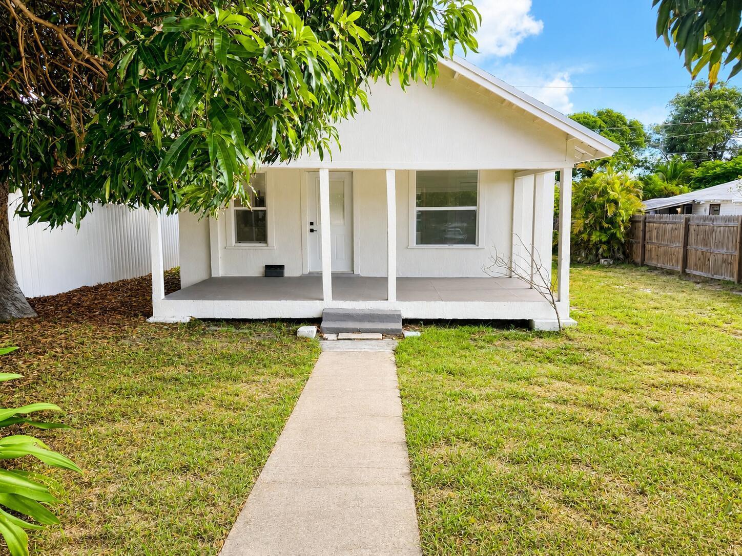 Beautifully renovated 2-bedroom, 1-bath home in the desirable Poinciana Park neighborhood featuring a brand-new roof! This move-in-ready home features an open-concept floor plan with high ceilings, luxury vinyl plank flooring, abundant natural light, and a modern kitchen with shaker cabinets, quartz countertops, stainless steel appliances, and a spacious island. Enjoy the oversized backyard with plenty of room to entertain, garden, or add a pool. Conveniently located just minutes from Downtown West Palm Beach, Palm Beach Island, beaches, shopping, dining, I-95, and Palm Beach International Airport. No HOA!