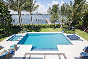Gorgeous new lakefront home sited at a high elevation above the lake trail, just completed - it's the only brand new designer furnished home on the market in Palm Beach. With deep water dock and 130' of lake front, just 3 blocks north of Wells Road, this elegant 2-story Georgian features water views from the kitchen, family room, living room, library, 1st & 2nd floor master suites + 3 additional bedrooms. Multiple terraces, a billiard room and bar, 4-car garage, whole house generator and gated entry court complete this stunning new construction.