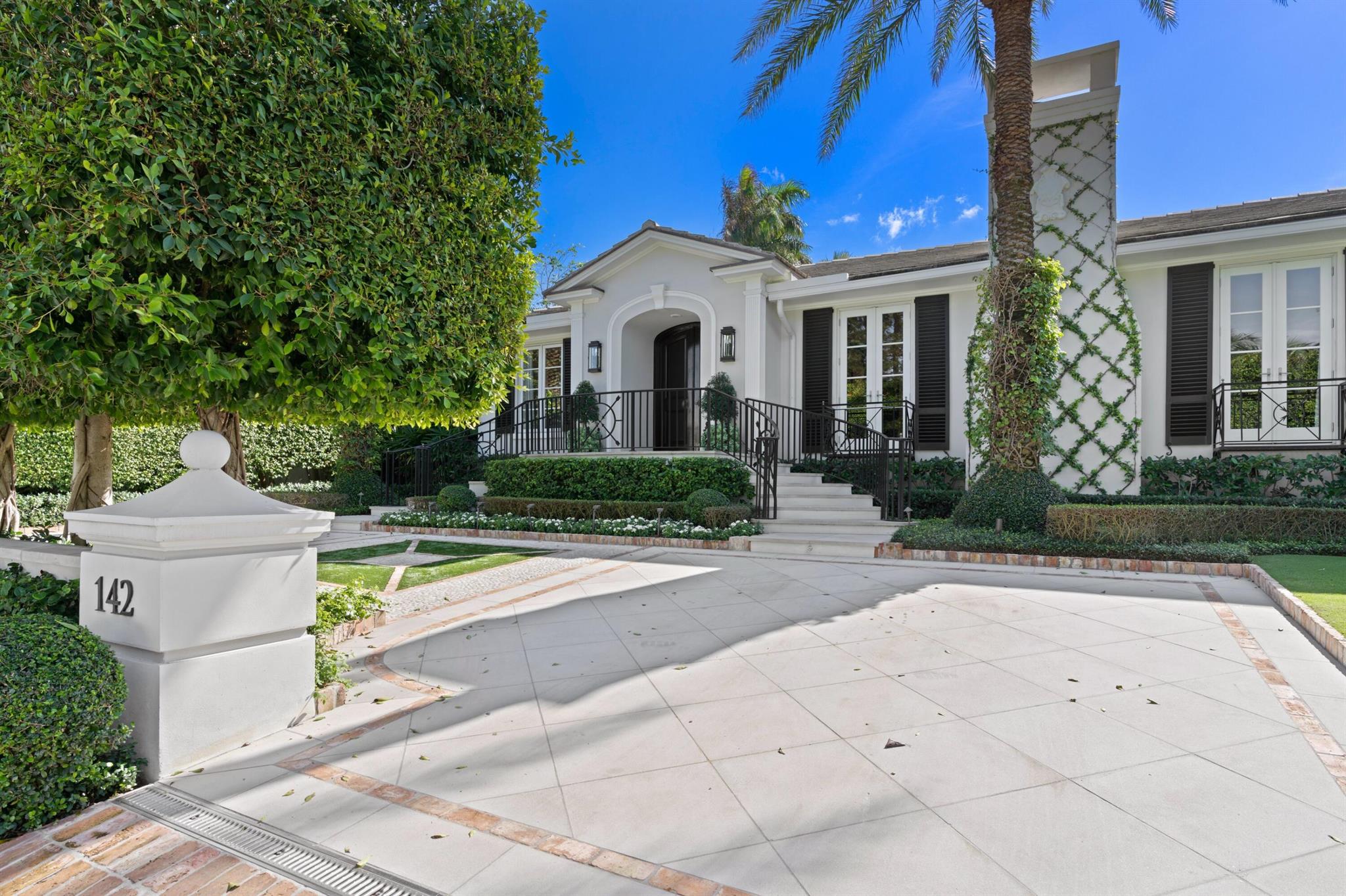 Welcome to 142 Via Palma. This elegant residence is an entertainer's paradise located just steps to Mar-a-Lago in the exclusive estate section enclave of Palm Beach Island. Nestled intimately in between the ocean and intracoastal with deeded beach access, Via Palma is a broad private street, recently upgraded with a lovely view of the Intracoastal and an easement for resident's use. This gracious estate has high ceilings throughout, and generous formal living spaces that flow directly to the large terrace overlooking the pool. The house has two large bedrooms, each of which can be used as a primary suite. The white gourmet kitchen with double sided Sub Zero and large wine refrigerator can accommodate large families and entertainers alike. The light flooded interiors, with large windows and French doors, offer a spacious well conceived open floor plan with 7,633 total square feet +/- including 4 bedrooms, one of which is a separate 1 bedroom guest apartment appointed with Waterworks hard surfaces and plumbing, and its own entrance and patio. The living room boasts a large fireplace, adding an architectural focal point to the space. Windows and doors are hurricane rated and the large generator is able to run the entire home. The estate has a comprehensive security system with cameras covering the front, sides and backyard. Sitting at a particularly high elevation on an oversized 17,480 square foot lot, the extremely private property includes a true 50 foot heated lap pool and pristine grounds designed by the acclaimed landscape architectural firm, Nievera Williams. The gardens offer terraced landscaping "rooms," each with a beautiful vistas, mature landscape, and architectural features. The property has a circular front driveway and a long Chicago brick back driveway that can accommodate multiple vehicles. The double doored garage offers space for a gym or a single car while the second garage bay is able to fit several cars. This space leads to an immense storage area not typical for a Palm Beach home. Downstairs, in addition to extraordinarily large department-store style closets, you'll find a formal butlers pantry with Waterworks hard surfaces, plumbing, a large washer and dryer with a designated clothes drying area, and a large sub-zero for catering and residence overflow needs. Located ideally just steps from the beach and Intracoastal, and just mere minutes by car from Worth Avenue and all the best of Palm Beach Island entertainment, this exquisite residence offers a winning combination of privacy and also accessibility to the Town of Palm Beach, West Palm Beach, and Palm Beach International Airport. 142 Via Palma embodies the epitome of classic, quintessential Palm Beach living, and is ready for immediate enjoyment. 

DISCLAIMER: Information published or otherwise provided by the listing company and its representatives including but not limited to prices, measurements, square footages, lot sizes, calculations, statistics, and videos are deemed reliable but are not guaranteed and are subject to errors, omissions or changes without notice. All such information should be independently verified by any prospective purchaser or seller. Parties should perform their own due diligence to verify such information prior to a sale or listing. Listing company expressly disclaims any warranty or representation regarding such information. Prices published are either list price, sold price, and/or last asking price. The listing company participates in the Multiple Listing Service and IDX. The properties published as listed and sold are not necessarily exclusive to listing company and may be listed or have sold with other members of the Multiple Listing Service. Transactions where listing company represented both buyers and sellers are calculated as two sales. "No payments made until title passes" Some affiliations may not be applicable to certain geographic areas. If your property is currently listed with another broker, please disregard any solicitation for services. Information published or otherwise provided by seller, listing company or its representatives is deemed reliable but are not guaranteed and subject to errors, omissions, or changes without notice. Copyright 2025 by the listing company. All Rights Reserved.