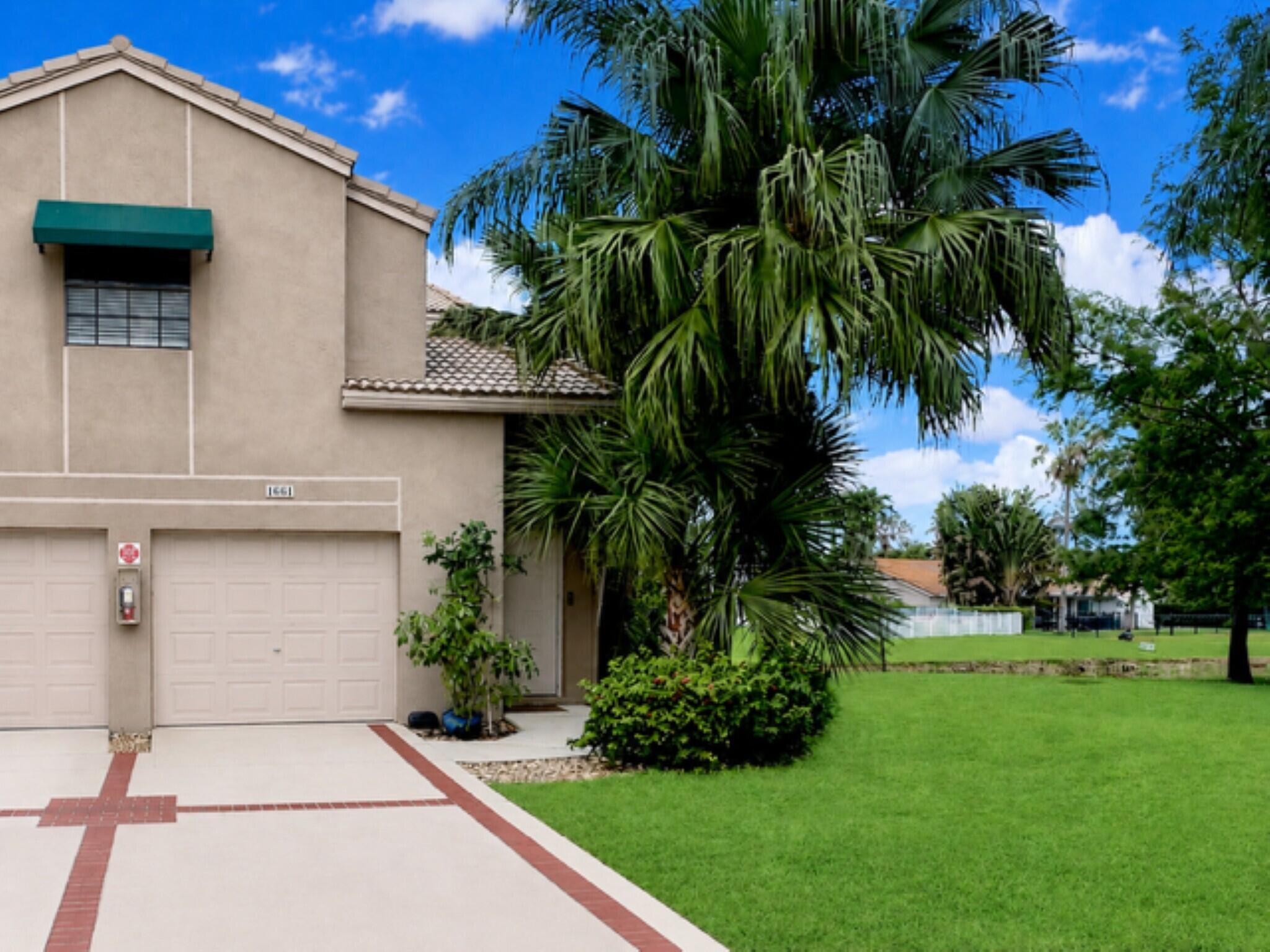Welcome to this beautiful 3-bedroom, 2-bath corner residence with a 1-car garage and fantastic water views! This open-concept floor plan features a bright living area with soaring vaulted ceilings and an updated kitchen with granite countertops and stainless-steel appliances. The primary suite and secondary bedroom features walk-in closets, providing ample storage and comfort. Unwind on the private balcony overlooking the water, the perfect spot to enjoy peaceful mornings and relaxing evenings. For additional leisure, take a short walk to the community pool to unwind and enjoy the South Florida lifestyle. The association covers water, lawn care, trash, roof repairs, exterior maintenance, and building insurance.