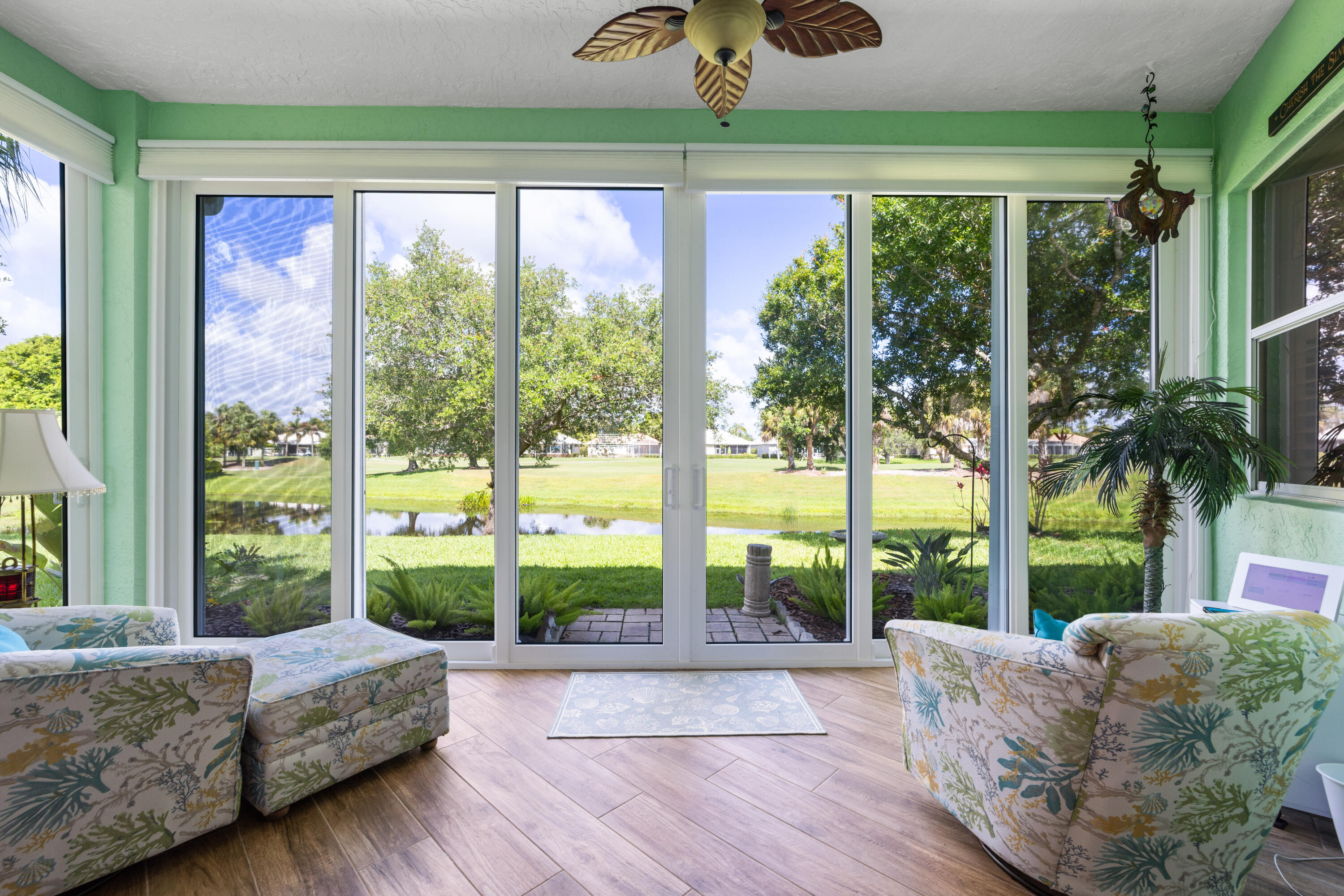 Luxury living in the prestigious Monarch Country Club with this completely renovated and impeccably maintained 2 bed, 2 bath villa offering 1,720 sqft living space and 2,197 total sqft. Designed for comfort and style, this extended residence features all impact glass windows and sliders, including the enclosed rear patio, providing peace of mind and protection. The interior showcases wood look tile flooring set on the diagonal, plantation shutters, blackout electric shades, crown molding, and a beautifully remodeled primary bath. Enjoy breathtaking golf course and lake views from the extended patio, surrounded by lush landscaping. Additional highlights include newer appliances, fiber optic internet, a 2018 A/C, a 2020 flat tile roof, and a spacious two car garage.  A truly stunning villa in one of the area's most sought after golf course communities.