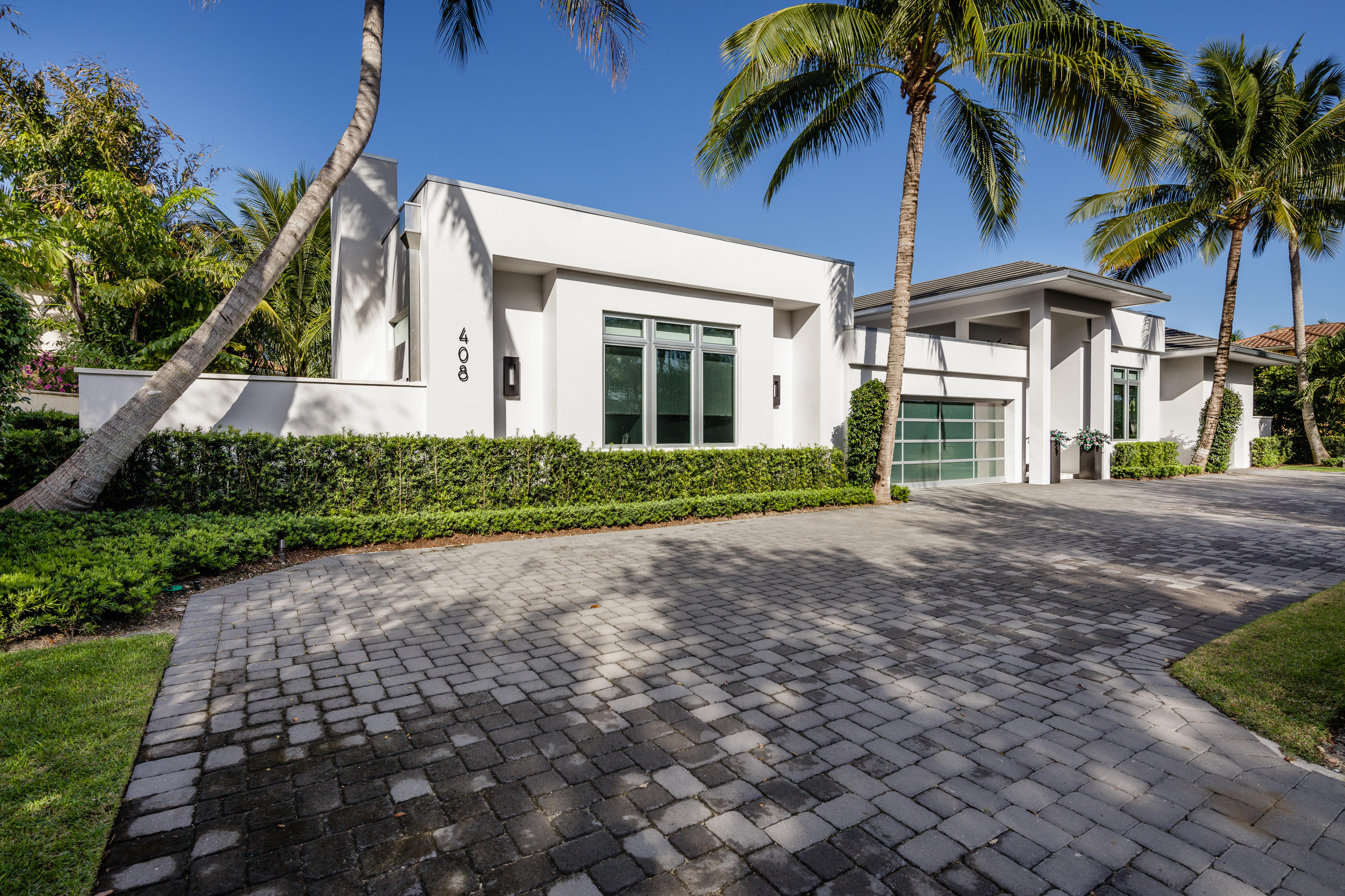 This home was meticulously rehabilitated in 2013, improved and expanded from the ground up, with the interior being completely reconfigured in order to create the open and inviting living and entertaining space that it has become. 5 bedroom, 5 1/2 bath home with separate 2 bedroom guest wing with private terrace in the main house and a one bedroom free standing guest house. Limestone floors throughout, ceiling detailing creates perfect room proportion, light and bright with transom windows. Impact windows and doors, whole house generator, Lutron lighting, indoor/outdoor music system. Island kitchen with breakfast bar, 6 burner Wolf range (double oven), Sub zero fridge and separate freezer, Miele dishwasher, pendant lights, glass tile backsplash, custom wood soft close cabinets. Night lighted garages viewable thru glass garage doors. Enjoy the outdoors with heated pool and hot tub, fire pit, summer kitchen, rear yard that may be used as a soccer field, marble floored/lighted exterior basketball court, and private dock with sundeck for up to 60' boat. Required golf membership purchase conveys all the first class amenities of Admirals Cove including two renovated clubhouses, 45 holes of golf, 5 restaurants, 63 slip brand new marina with floating docks, Yacht Club, 13 har tru tennis courts, state of the art fitness and spa, Covesters kids club and Platinum service.