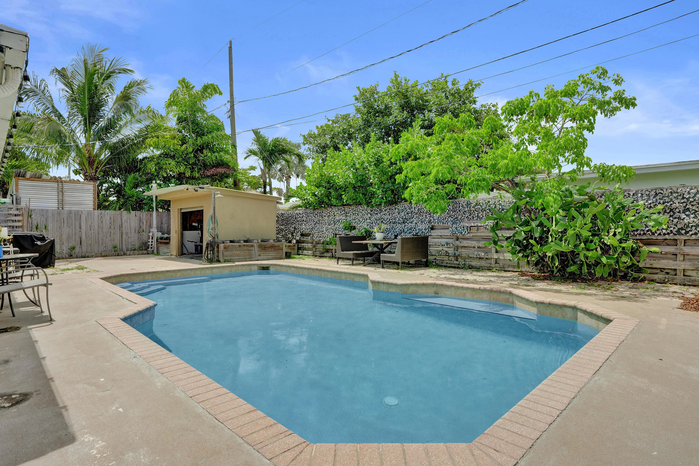 Welcome home to this single-story residence located in Fairlawn 1st Add, Deerfield Beach, FL. This residence is ready for your vision. Located on a corner lot, the garden/ pool area holds tremendous potential. Mature fruit bearing Mango trees grace the pool area. This three-bedroom, two-bathroom home offers 1,368 square feet for everyday living. The neutral finishes and porcelain tile floors will adapt to any interior style. Whether you're seeking a place to establish roots or expand your investment portfolio, this well-proportioned home in an established quiet community presents a solid opportunity to own quality residential real estate in Deerfield Beach.