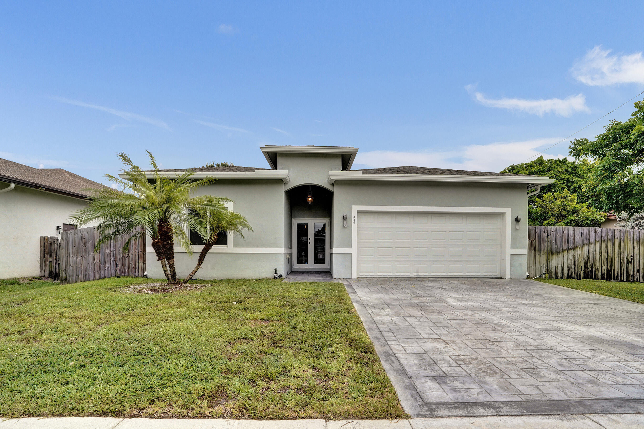 2021 MODERN BUILDER HOUSE IN POMPANO BEACH, NO HOA, 4BEDS 3BATHS 2CAR-GARAGE. This mint condition property offers 1,981sqft AC, 9000sqft lot, 10ft height ceiling. Beautiful large entrance leading to a magnificent open floor concept design. Huge Kitchen with granite countertops, full backsplash, large kitchen island, steel appliances. Large Master bedroom with spaces walk-in closet, tub and shower/double sinks for his/her. 460sqft garage with epoxy floor, Washer/dryer seating on tile floor with its own sink. Impact windows and doors for the entire house include garage side door; all doors are covered by rolling shades for privacy. This house is well-cared for with attention to details. All wood fence around, room for pool. Driveways are solid stamp concrete. ONE OF A KIND and A RARE FIND. This house is 2 minutes away from newly development of Hunter Manor Community with 59 newly built houses by  D-R-HORTON during the last 2 years. It is 5 minutes to Bank, shopping center, Walmart, post office, 16 minutes to the Beach, easy access to I95.