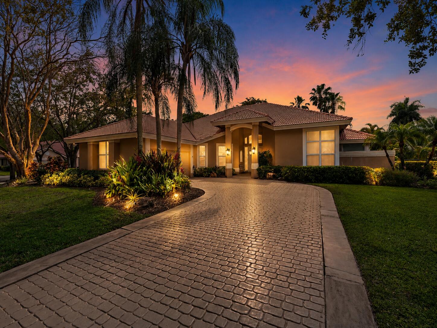 WESTON, TEQUESTA LAKES estate at 1207 Manor Dr S, in Weston and offers 5 bedrooms, 4.5 bathrooms, and 4,050 square feet of living space, on an expansive 16,450 square foot corner lot. Warm and inviting favorited floorplan for families to spread out and have their own space. Thoughtfully maintained and updated, the home features several important recent improvements including IMPACT WINDOWS, both air conditioning systems recently replaced, a new dishwasher, and a new garage door opener. Just move in. Nothing to think about. Inside, the residence showcases a warm and sophisticated design with hardwood, marble, and tile flooring, soaring ceilings, and abundant natural light throughout.  The chef ready kitchen is designed for both everyday living and entertaining, opening seamlessly to a cozy family room that flows directly to the pool and patio, creating the ideal indoor outdoor Florida lifestyle. A formal dining room provides an elegant setting for gatherings, while the spacious primary suite offers a peaceful retreat with luxurious finishes and tranquil outdoor views. Outside, the home continues to impress with a fenced side yard featuring artificial turf, perfect for football or soccer, along with a private backyard that creates a serene and relaxing oasis. Nestled on a quiet, picturesque street, this property blends timeless elegance with modern comfort. Located within Tequesta Lakes, residents enjoy a sought after lifestyle surrounded by beautiful oak lined streets, nearby Peace Mound Park, and convenient access to golf, tennis, pickleball, dining, and more, all within a short drive or bike ride. This is a rare opportunity to own in one of Weston's most desirable gated communities.
