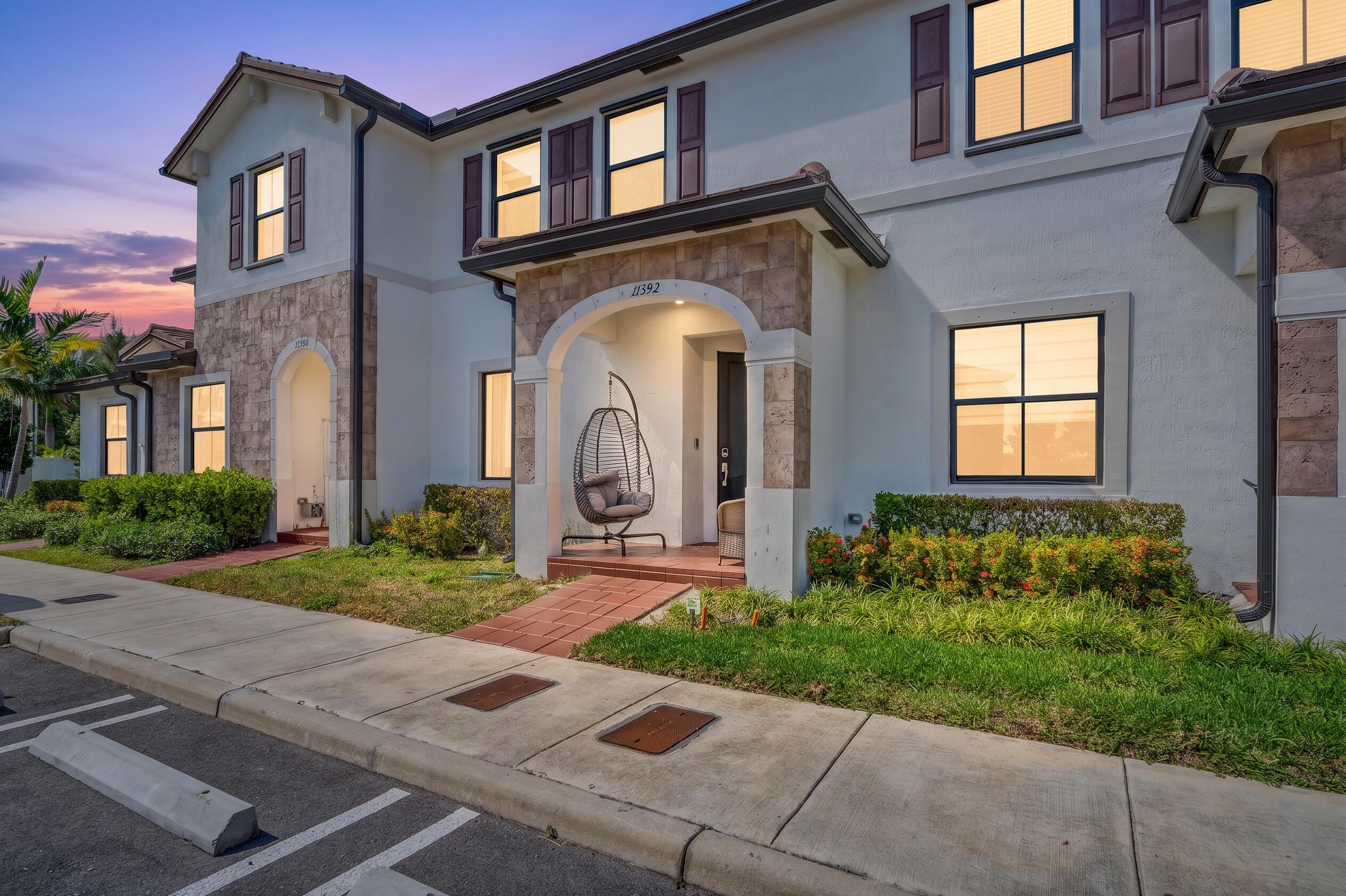 Best Price in Aquabella! Motivated Seller! Don't miss this upgraded 3-bedroom, 2.5-bath fee simple townhome. This home offers fully paid impact windows and doors, an open-concept layout with spacious living and dining areas, and an oversized kitchen with newer stainless steel appliances that opens to a comfortable family room. Relax in your private backyard with artificial turf and a retractable roof, overlooking open green space with no rear neighbors. The primary and second bedrooms both feature walk-in closets. Additional highlights include a new dishwasher, in-unit washer and dryer, HOA-covered AT&T internet, and two assigned parking spaces directly in front of the home. Enjoy two clubhouses, pools, fitness centers, a children's splash zone.