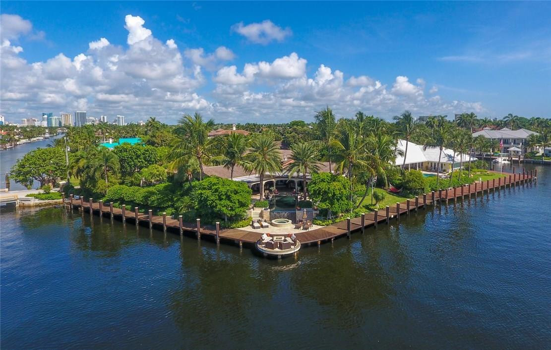 Breathtaking waterway views, Point Lot boasting 275 feet of deep waterfront. 2 power stations & enormous straight line dockage for 2 large yachts. Exquisitely updated warm contemporary estate. The custom open kitchen is a masterpiece with waterway views from the dining area. Oversized great room, media room. home gym & lrg master suite with 2 master bathrooms. Large cover loggia & full summer kitchen overlook the infiniti pool & spa. Full generator,  beach club, marina & guard house entry. Sq ft from bcpa
