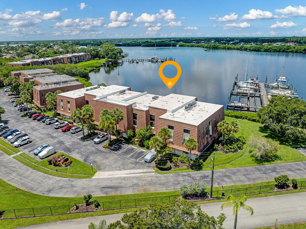 Enjoy waterfront living in this beautifully updated 2-bedroom, 2-bath CBS condo overlooking scenic Kitching Cove. The remodeled kitchen features white shaker cabinets, stainless steel appliances, and opens to spacious living areas with luxury vinyl flooring throughout. Both bathrooms have been tastefully updated with large-format ceramic tile. Relax on the screened porch while taking in peaceful water views, or take advantage of the available boat dock with ocean access for boating, fishing, and kayaking. The community roof was replaced in 2025, offering added peace of mind. Enjoy the added convenience of having an elevator. HOA  includes water, cable, internet, trash, sewer, building insurance / maintenance, pool, clubhouse, sauna, pickleball, and more! Don't want to miss this paradise!