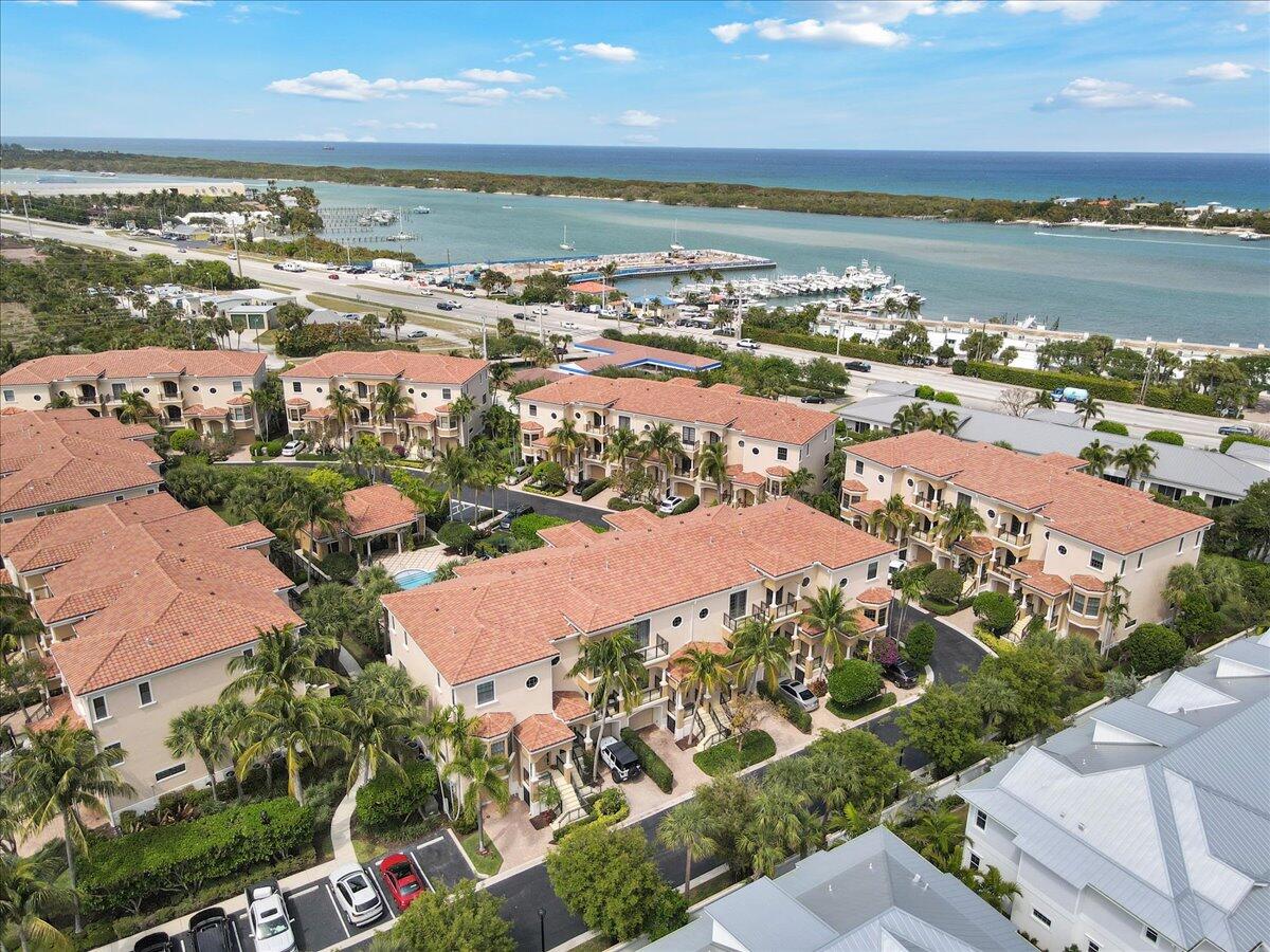 Rare opportunity in one of the area's most unique communities! 3 story split level CBS townhouse with its own private elevator, garage, pool view, impact glass and smart home system, Starlink, and pre-wired for a generator. 3 bedrooms, 3 full baths, half bath, 2 wet bars, dining and breakfast area, 11' ceilings, ground level patio and 3 balconies.   Kitchen features stainless appliances and gas stove, Barnwood wall and bar add additional rustic charm. Tesla charger installed and included in sale.  Exceptional location on US1 by the intracoastal and all of Tequesta's best shopping and dining. Convenient to Jupiter and Juno's beaches, a short drive to Abacoa, Stuart, West Palm, and an easy ride to 95 and the Turnpike. HOA fee includes roof maintenance, exterior building insurance, cable, common areas, pool and lawn service, and security gate.