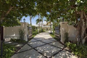 Custom Built British West Indies Intracoastal Estate.  This contemporary estate has top of the line finishes, 3 Car garage and guest house.  Unbelievable intraocastal water views with 102+/- feet of direct intracoastal and a new 93ft+/- dock. Enjoy your own private beach and lush tropical landscaping. The information herein is deemed reliable and subject to errors, omissions or changes without notice.  The information has been derived from architectural plans or county records. Buyer should verify all measurements. ***SEE SUPPLEMENT*** The lush Old Florida tranquility of Hypoluxo Island provides the setting for this luxurious estate on the eastern shore of the Intracoastal Waterway, giving an enchanting view over the wide waters to the mainland coastline in the distance.  Secluded by a canopy of leafy foliage, a walled and gated entry gives a striking approach to the architect-designed coastal-inspired estate custom built in 2011 by Steve Cury Construction, a high-end Palm Beach-based firm with more than two decades of experience.  The fine finishes used throughout were selected with special attention to detail.

Bougainvillea-cloaked arches frame the covered entryway into the light and airy interiors that give a refined inflection with traditional design elements interpreted in a fresh, modern way.  At the heart of the house, the double-height great room with stately fireplace opens its doors to the sweeping waterfront view through the entertainment lanai.  Taking in the splendor of the Intracoastal Waterway and South Florida sunset, this true outdoor living room leads out to the waterside lawns with inviting spots to relax by the fire-pit and saltwater lap pool or on the private sandy beach, with the yachter's deepwater dock placed to the side.

Five bedroom suites feature the calm, casually elegant master quarters which open to a breezy awning-covered balcony terrace basking in the fresh air and gorgeous waterway views.  The guest house provides self-contained living quarters as an added luxury of this compound-like estate tucked away in the rare tropical beauty of exclusive Hypoluxo Island.

Location
South Atlantic Drive, Lantana, Florida.  Hypoluxo Island preserves Old Florida tranquility on a scenic barrier island surrounded by the Intracoastal Waterway in the heart of South Florida's Gold Coast, midway between Palm Beach and Boca Raton.  Just across the bridge is the sugar-sand ocean beachfront of Manalapan, home to the Five-Diamond Eau Palm Beach Resort & Spa.

Property
Enchanting wide-open waterway vistas and brilliant sunsets provide the backdrop for this direct Intracoastal estate on 101± feet of shoreline featuring a private sandy beach and a 93±-foot-long, full-service deepwater dock that can accommodate multiple vessels and includes a 16,000±-pound boat lift.  Perfect for outdoor entertaining, the coffer-ceilinged waterside lanai is served by a high-end summer kitchen.  Broad lawns stretch to the 60±-foot saltwater lap pool, next to a fire-pit adding a dramatic night-time effect.  Lushly landscaped for privacy and beauty, the property is served by a gated, double-entry drive finished in inlaid stone.

Residence
This custom-built coastal-inspired residence is beautifully scaled in a grand total of 9,291± square feet with five bedrooms, five and a-half baths, and a three-bay garage.  High-end finishes and features include limestone and Brazilian cherry floors, crown-molded volume ceilings, impact-glass windows and exterior doors, a concrete tile roof, sophisticated security system, and Sonos indoor/outdoor sound system.  There is also an elevator-ready shaft.

First Floor:  Inside the glass-paned double doors, the limestone foyer captures the waterfront view through the double-height great room, open to the balconied upper gallery, with a floor-to-ceiling fireplace as a focal point.  Glass doors open this dramatic room to the waterside lanai in a perfect layout for entertaining.  Through wide entryways, the wainscoted dining room with coffered ceiling opens to the front porch.  Placing an equal emphasis on function and design, the chef's kitchen offers custom cabinetry, marble counters and backsplashes, a wood-topped island, two Marvel wine coolers, and Thermador appliances including the professional-style gas range, double ovens, refrigerator/freezer, dishwasher, and coffee/espresso system.  Set off by a richly finished tongue-and-groove-paneled ceiling, the family room is wrapped with glass pocket doors that completely open to the waterside lanai.  Also leading to the lanai, the club room has Brazilian cherry floors and provides a powder room that doubles as the cabana bath.  The private office is off the foyer.

Second Floor:  Atop the staircase, the wraparound gallery overlooks the great room below, and leads into a loft-style second family room with Brazilian cherry floor, rich wood coffered ceiling, brise soleil sun shades, and French doors to a waterside balcony.  Set off by a peaked, wood-paneled ceiling, the airy master suite is generously sized to include a sitting area with French doors to a balcony terrace, covered by awning panels, giving sensational views over the Intracoastal Waterway.  Complete with two customized walk-in closets, the luxurious marble-and-granite master bath also features an alcove pedestal tub, a multi-head shower, and two separate water closets.  Three more bedrooms with walk-in closets and en-suite baths all open to balconies.

Guest House:  Having private outside access, the guest house contains a living room, kitchenette, bedroom, and bath.

Disclaimer: The information provided herein including but not limited to measurements, square footages, lot sizes, calculations and statistics have been obtained and conveyed from third parties such as the applicable Multiple Listing Service, public records as well as other sources. All information including that produced by the Sellers or Listing Company are subject to errors, omissions or changes without notice and should be independently verified by any prospect for the purchase of a Property.  The Sellers and Listing Company expressly disclaim any warranty or representation regarding all enclosed information.  Prospects' use of any information herein is acknowledgement of this disclaimer and that Prospect shall perform their own due diligence.  Prospects shall not rely on this information when entering into a contract for sale and purchase.  Some affiliations may not be applicable to certain geographic areas. If your property is currently listed, please do not consider this a solicitation.   In the event a Buyer defaults, no commission will be paid to either Broker on the Deposits retained by the Seller. "No Commissions Paid until Title Passes."    Buyer pays title insurance, Florida documentary stamps, and all other closing costs for New Construction and land use. Copyright 2016 Listing Company.  All Rights Reserved.