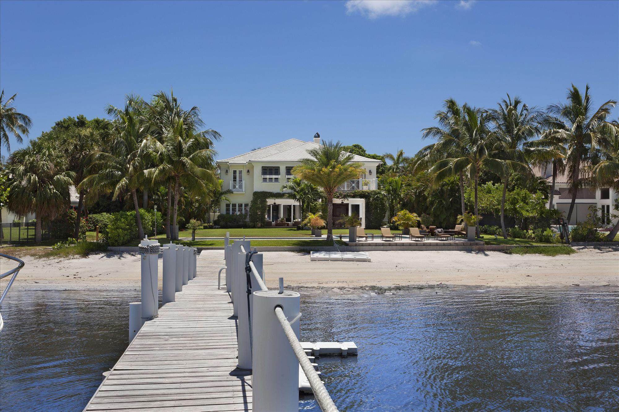 Custom Built British West Indies Intracoastal Estate.  This contemporary estate has top of the line finishes, 3 Car garage and guest house.  Unbelievable intraocastal water views with 102+/- feet of direct intracoastal and a new 93ft+/- dock. Enjoy your own private beach and lush tropical landscaping. The information herein is deemed reliable and subject to errors, omissions or changes without notice.  The information has been derived from architectural plans or county records. Buyer should verify all measurements. ***SEE SUPPLEMENT*** The lush Old Florida tranquility of Hypoluxo Island provides the setting for this luxurious estate on the eastern shore of the Intracoastal Waterway, giving an enchanting view over the wide waters to the mainland coastline in the distance.  Secluded by a canopy of leafy foliage, a walled and gated entry gives a striking approach to the architect-designed coastal-inspired estate custom built in 2011 by Steve Cury Construction, a high-end Palm Beach-based firm with more than two decades of experience.  The fine finishes used throughout were selected with special attention to detail.

Bougainvillea-cloaked arches frame the covered entryway into the light and airy interiors that give a refined inflection with traditional design elements interpreted in a fresh, modern way.  At the heart of the house, the double-height great room with stately fireplace opens its doors to the sweeping waterfront view through the entertainment lanai.  Taking in the splendor of the Intracoastal Waterway and South Florida sunset, this true outdoor living room leads out to the waterside lawns with inviting spots to relax by the fire-pit and saltwater lap pool or on the private sandy beach, with the yachter's deepwater dock placed to the side.

Five bedroom suites feature the calm, casually elegant master quarters which open to a breezy awning-covered balcony terrace basking in the fresh air and gorgeous waterway views.  The guest house provides self-contained living quarters as an added luxury of this compound-like estate tucked away in the rare tropical beauty of exclusive Hypoluxo Island.

Location
South Atlantic Drive, Lantana, Florida.  Hypoluxo Island preserves Old Florida tranquility on a scenic barrier island surrounded by the Intracoastal Waterway in the heart of South Florida's Gold Coast, midway between Palm Beach and Boca Raton.  Just across the bridge is the sugar-sand ocean beachfront of Manalapan, home to the Five-Diamond Eau Palm Beach Resort & Spa.

Property
Enchanting wide-open waterway vistas and brilliant sunsets provide the backdrop for this direct Intracoastal estate on 101± feet of shoreline featuring a private sandy beach and a 93±-foot-long, full-service deepwater dock that can accommodate multiple vessels and includes a 16,000±-pound boat lift.  Perfect for outdoor entertaining, the coffer-ceilinged waterside lanai is served by a high-end summer kitchen.  Broad lawns stretch to the 60±-foot saltwater lap pool, next to a fire-pit adding a dramatic night-time effect.  Lushly landscaped for privacy and beauty, the property is served by a gated, double-entry drive finished in inlaid stone.

Residence
This custom-built coastal-inspired residence is beautifully scaled in a grand total of 9,291± square feet with five bedrooms, five and a-half baths, and a three-bay garage.  High-end finishes and features include limestone and Brazilian cherry floors, crown-molded volume ceilings, impact-glass windows and exterior doors, a concrete tile roof, sophisticated security system, and Sonos indoor/outdoor sound system.  There is also an elevator-ready shaft.

First Floor:  Inside the glass-paned double doors, the limestone foyer captures the waterfront view through the double-height great room, open to the balconied upper gallery, with a floor-to-ceiling fireplace as a focal point.  Glass doors open this dramatic room to the waterside lanai in a perfect layout for entertaining.  Through wide entryways, the wainscoted dining room with coffered ceiling opens to the front porch.  Placing an equal emphasis on function and design, the chef's kitchen offers custom cabinetry, marble counters and backsplashes, a wood-topped island, two Marvel wine coolers, and Thermador appliances including the professional-style gas range, double ovens, refrigerator/freezer, dishwasher, and coffee/espresso system.  Set off by a richly finished tongue-and-groove-paneled ceiling, the family room is wrapped with glass pocket doors that completely open to the waterside lanai.  Also leading to the lanai, the club room has Brazilian cherry floors and provides a powder room that doubles as the cabana bath.  The private office is off the foyer.

Second Floor:  Atop the staircase, the wraparound gallery overlooks the great room below, and leads into a loft-style second family room with Brazilian cherry floor, rich wood coffered ceiling, brise soleil sun shades, and French doors to a waterside balcony.  Set off by a peaked, wood-paneled ceiling, the airy master suite is generously sized to include a sitting area with French doors to a balcony terrace, covered by awning panels, giving sensational views over the Intracoastal Waterway.  Complete with two customized walk-in closets, the luxurious marble-and-granite master bath also features an alcove pedestal tub, a multi-head shower, and two separate water closets.  Three more bedrooms with walk-in closets and en-suite baths all open to balconies.

Guest House:  Having private outside access, the guest house contains a living room, kitchenette, bedroom, and bath.

Disclaimer: The information provided herein including but not limited to measurements, square footages, lot sizes, calculations and statistics have been obtained and conveyed from third parties such as the applicable Multiple Listing Service, public records as well as other sources. All information including that produced by the Sellers or Listing Company are subject to errors, omissions or changes without notice and should be independently verified by any prospect for the purchase of a Property.  The Sellers and Listing Company expressly disclaim any warranty or representation regarding all enclosed information.  Prospects' use of any information herein is acknowledgement of this disclaimer and that Prospect shall perform their own due diligence.  Prospects shall not rely on this information when entering into a contract for sale and purchase.  Some affiliations may not be applicable to certain geographic areas. If your property is currently listed, please do not consider this a solicitation.   In the event a Buyer defaults, no commission will be paid to either Broker on the Deposits retained by the Seller. "No Commissions Paid until Title Passes."    Buyer pays title insurance, Florida documentary stamps, and all other closing costs for New Construction and land use. Copyright 2016 Listing Company.  All Rights Reserved.