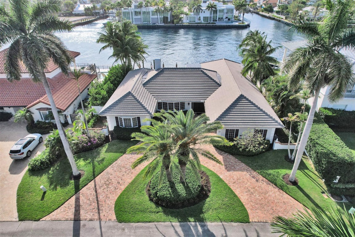 An elegant estate located in the exclusive, gated Village of Sea Ranch Lakes—complete with its own private beach, Beach Club, and police force. This beautifully maintained home with 100 ft of direct, unobstructed Intracoastal views has hardwood floors, generously sized family & living rooms, two fireplaces, impact windows, French doors & plantation shutters throughout. The spacious primary suite offers dual walk-in closets and a spa-like bath. Two additional bedrooms each boast generous walk-in closets & en suite full baths, creating comfort and privacy for family or guests. Other features include a 2021 roof, newer AC units, tankless water heater, pool, cabana bath & high-end gas appliances. This home is a sophisticated coastal retreat ideal for relaxed living and stylish entertaining.