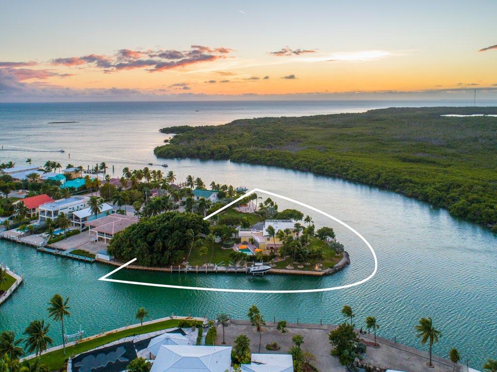 Rare Opportunity! Price adjustment of $1,095,000. Now offered at $6,900,000. Bring all offers! Stunning Tropical Compound! Enter the Private gates that open to this amazing Florida Keys Gem. One of a kind opportunity on 1.2 Acres of manicured grounds, palm trees and its own white sandy private beach. Yacht/Sport Fisherman's paradise with deep water dockage. 625+/- Feet of waterfront. Incredible sunrise and sunsets with a towering banyan tree. Minutes away from the best diving and fishing the Keys has to offer. 4 Bedroom 4.1 Baths, Chefs Kitchen, Open Floor Plan. Sip a cocktail at the outdoor bar and lounge at the pool. Roof top decks to gaze out at the stars and dine al fresco. Just minutes from The Marathon Airport. This Trophy Property is located in Sombrero Beach and and is the True definition of Barefoot Luxury. First time on the market in years! Fully Furnished and ready to Enjoy!