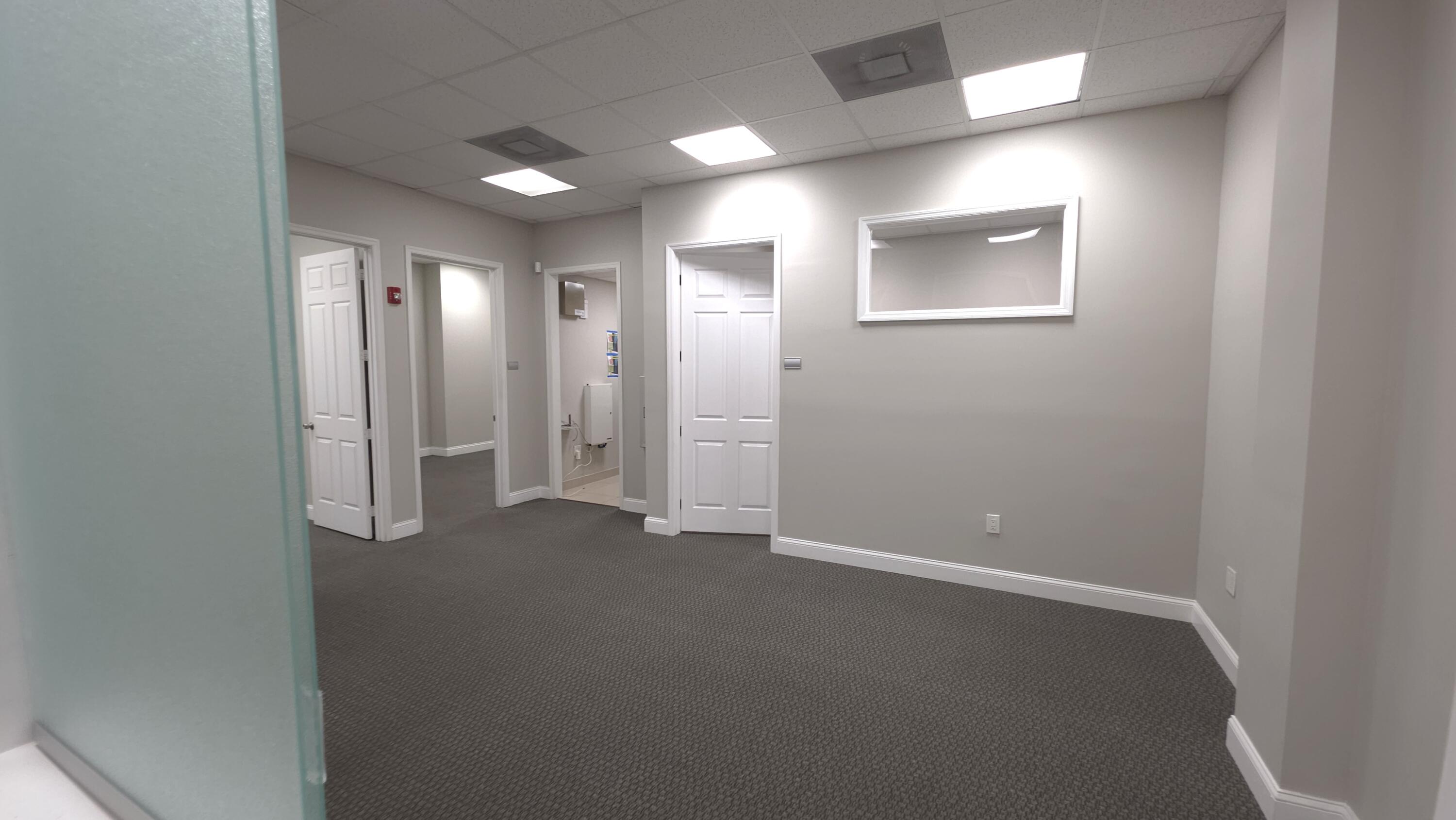 Stunning Executive office suite in Whispering Woods Commerce Center. Custom Office Fully Built Out. Elevate your business presence with this meticulously maintained ,rarely available first floor office suite. Spanning 932 sq ft  of functional high-end professional space. This unit is move in ready and designed for maximum efficiency and client impact ! Thoughtfully partitioned to accommodate a variety of professional services ,New Flooring, New Custom Doors, Freshly Painted ! There are 3  private offices Generously sized with ample natural lighting. A professional Reception area with a welcoming entryway designed to provide an exceptional first impression for your clients. Includes a private in-suite bathroom ensuring privacy & ease for staff and clients Great Coral Springs/Parkland Area !