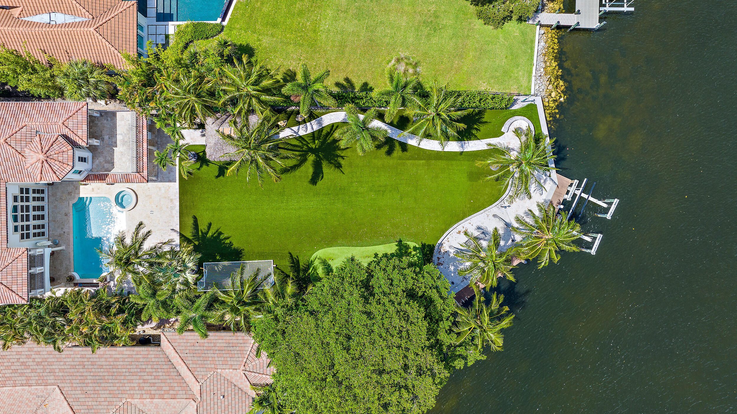 PRIVATELY GATED INTRACOASTAL ESTATE LOCATED IN COVETED PALM BEACH GARDENS WATERFRONT COMMUNITY, INTRACOASTAL PARK.  82' OF DIRECT INTRACOASTAL WATER FRONTAGE WITH NO WAKE ZONE AND NO FIXED BRIDGES MAKE THIS A BOATERS PARADISE.  THIS LIGHT AND BRIGHT MEDITERRANEAN ESTATE WITH FINE CUSTOM APPOINTMENTS IS TUCKED AWAY ON A LUSH, EXPANSIVE LOT THAT BOASTS PRIVACY, SWEEPING INTRACOASTAL VIEWS, A 40,000 PD BOAT LIFT, PRIVATE SANDY BEACH AREA, FIRE PIT, TIKI GAZEBO, LOGGIAS, CABANA BATH AND SECOND FLOOR BALCONIES OVERLOOKING DIRECT WATER VIEWS.  ENJOY THE INTRACOASTAL BREEZE OVER THE PUTTING GREEN, HEATED POOL/SPA AND SUMMER KITCHEN. THIS DEEP LOT OFFERS BEAUTIFUL MATURE TREES, LUSH LANDSCAPING, NEWER TURF AND MORE.  CRESTRON SYSTEM AND GAS GENERATOR.  THIS TRULY IS A REMARKABLE PROPERTY!