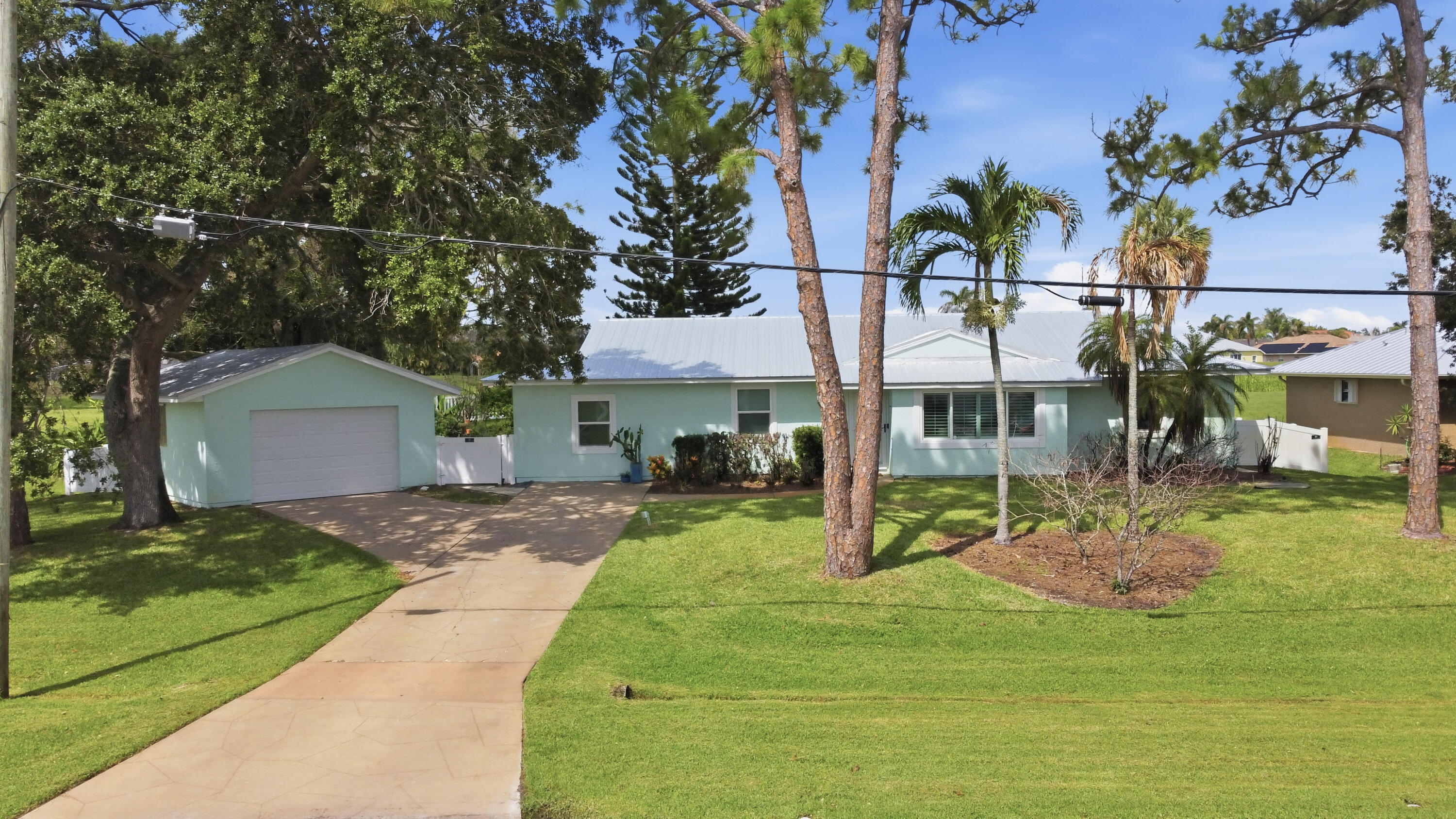 Waterfront homes with this much flexibility don't come around often. Situated on a 1/3-acre lot overlooking the C-24 Canal, this beautifully updated home offers long water views, a private dock rebuilt in 2020, and a newly fenced backyard with plenty of room to enjoy the outdoors. Inside, the fully permitted garage conversion creates valuable additional living space that can serve as a den, office, guest suite, or 4th bedroom. A separate 2-car garage with a workbench and extra storage provides room for projects, hobbies, or all your toys. Recent updates include a 2022 metal roof, remodeled kitchen and bathrooms, 2023 flooring, 2019 impact windows and doors, a whole-house generator installed in 2022, and hurricane protection throughout, including roll-down shutters for the air-conditioned Florida room. Whether you're looking for extra space, waterfront views, or a home with the big-ticket updates already completed, this one checks all the boxes. Call today for your private tour!