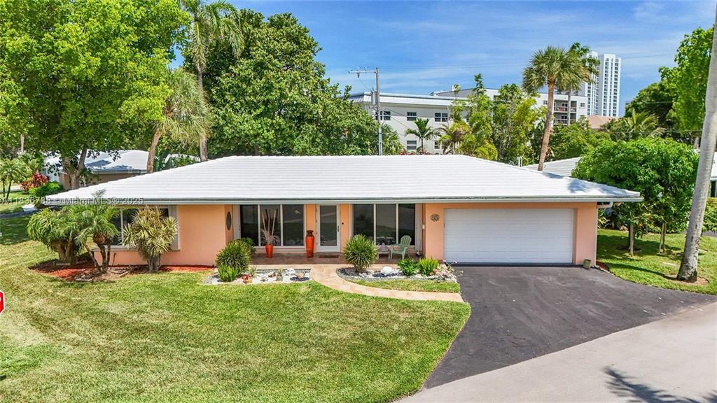 Beachside living in this stylish, move-in-ready 2-bedroom, 2.5-bath home with a full 2-car garage. Featuring terrazzo floors throughout, a beautifully updated kitchen and baths, and impact windows and doors for peace of mind. Laundry room has a separate tub sink, large enclosed storage room with shelves in the garage as well as an electric car charger. Enjoy the convenience of indoor laundry and a spacious backyard—perfect for relaxing or entertaining just moments from the beach!