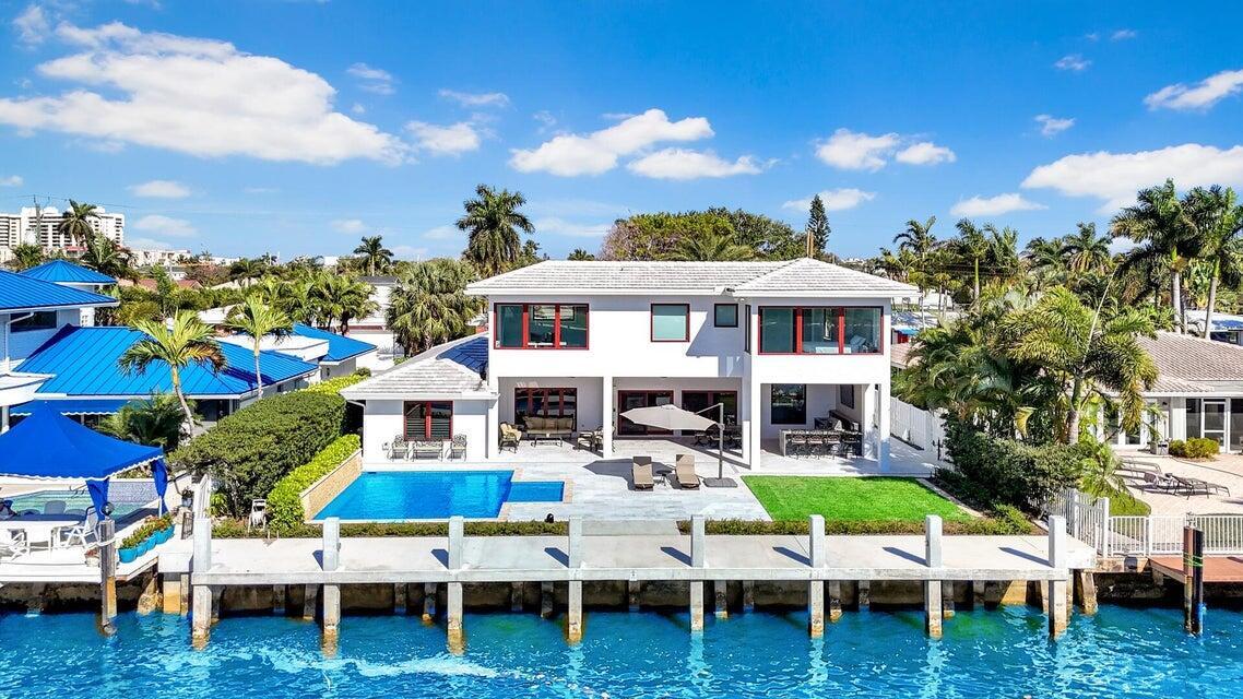 Step into a true boater's dream on the Intracoastal, where luxury, design, and direct ocean access come together with no fixed bridges. This fully reimagined waterfront estate showcases a brand-new 70'6" concrete dock, new seawall with king piles, batter piles, and panels—built for serious boating and effortless yachting lifestyle. Inside, the residence has been elevated to a high-end standard, featuring a designer gourmet kitchen with custom cabinetry, a Sub-Zero refrigerator, Wolf 6-burner gas range, double ovens, warming drawer, new wine fridge, and a blend of granite and butcher block surfaces that deliver both style and performance. Rich Brazilian hardwood flooring and oversized 24x48 polished tile flow throughout, complemented by crown molding, plantation shutters, motorized shades, and full impact glass—creating a seamless blend of sophistication and comfort. The newly constructed second level adds 962 square feet and introduces an impressive primary suite retreat, designed with spa-inspired finishes including a soaking tub, walk-in shower, dual vanities, and a spacious custom closet. A flexible office or guest suite completes the upper level, offering elevated views and versatility for today's lifestyle. Outdoors is where this home truly separates itself—crafted for entertaining and enjoying South Florida living at its finest. The backyard features a resort-style heated pool with a brand-new pool heater, sun shelf, and waterfall, alongside a covered patio with tongue-and-groove ceilings, LED lighting, integrated sound, and multiple lounging areas. The fully equipped summer kitchen includes a Weber Summit S grill, beverage refrigerator, icemaker, and sink—perfect for hosting at scale. Positioned just steps from the sand and minutes to the heart of Lauderdale-by-the-Sea, this property delivers the ultimate coastal lifestyle—luxury, location, and a world-class boating experience all in one.