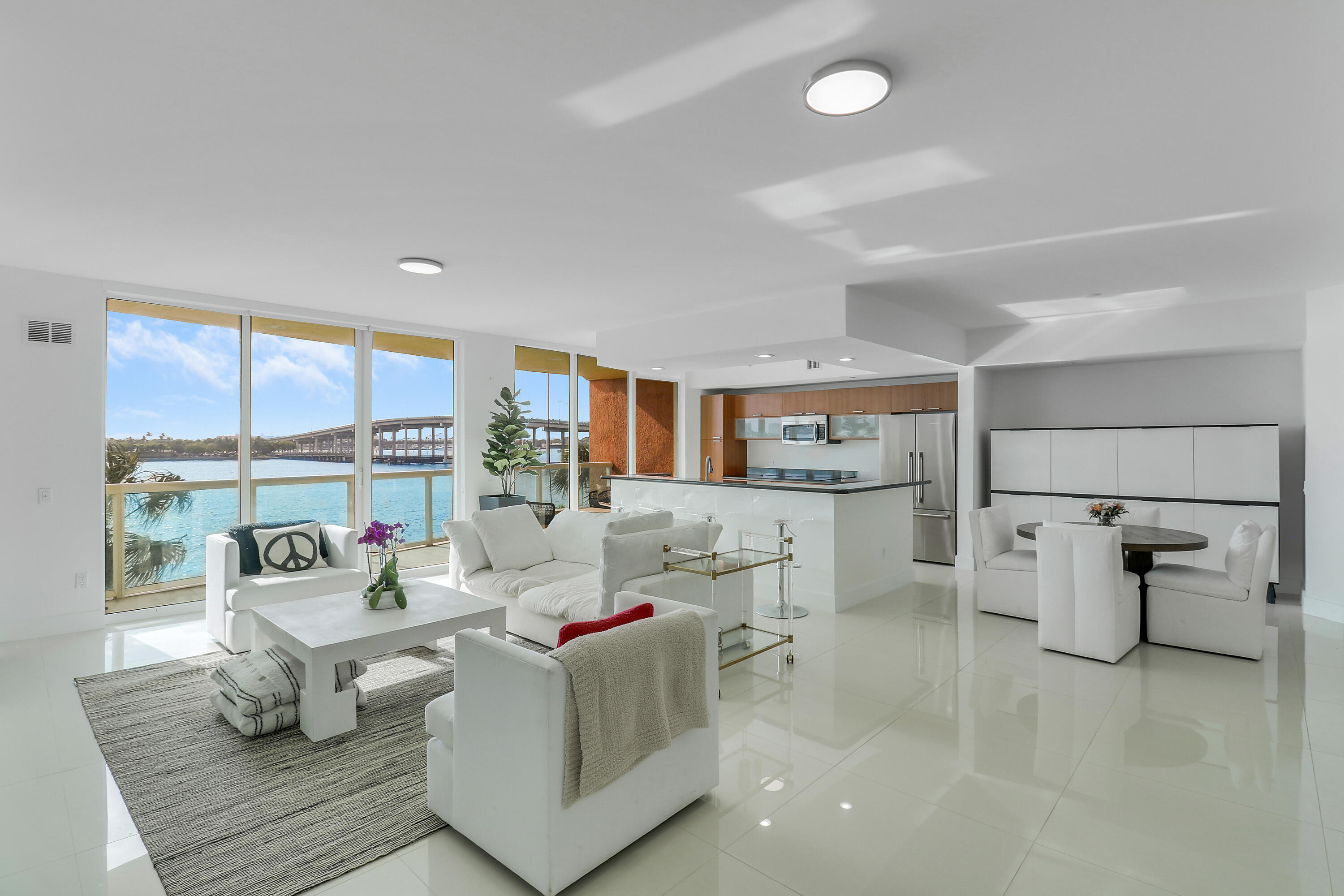 Rare end unit; highly sought after panoramic view extends from north end intracoastal to the sandbar and Peanut Island.   Immaculate 2/2 w/open den easily converts to 3rd bedroom; Fisher Paykel premium appliances; induction cooktop, oven and refrigerator. Gloss porcelain tile through living areas; motorized shades; master bedroom walk-in California closet, master bath double vanities, semi-private elevator.      Roof top heated pool, jacuzzi, grills, fully equipped gym, sauna, steam room, 4 pickleball courts, social/billiard rooms, manned 24-hour security, garage parking; adjoining full-service marina offers dry dock availability two minutes from one of safest inlets on east coast; area boasts national recognition for diving and as #1 Shore Dive in America. No fixed bridges. Minutes to beaches.