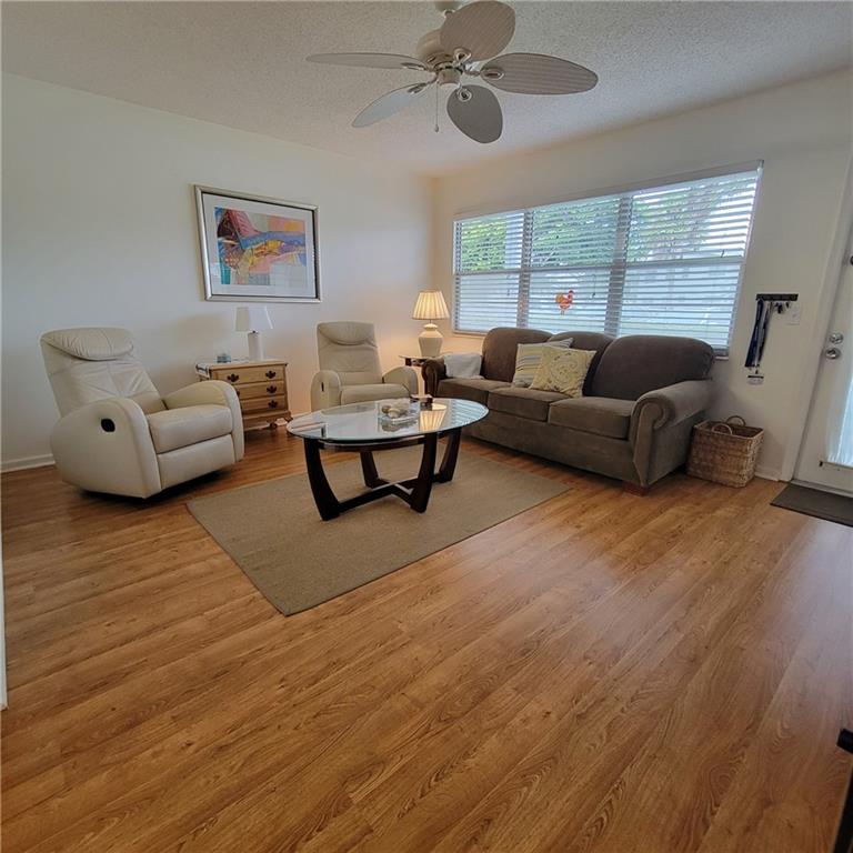 Great 1st floor unit in wonderful Harwood C. Beautiful Water View. One Bedroom, One Bath, with a great walk in shower. Newer Kitchen with wood cabinets. Must see the lovely Laminated floors thru out except in Sunroom which has tile. Home is furnished and ready for you. This well maintained building is surrounded by water and wonderful views. 3.3 Miles to beautiful Deerfield Beach. The parking spot is right outside your door  You also have a large storage unit in the laundry room #1010. Everything you need is in this unit dishes, pots & pans, silverware.