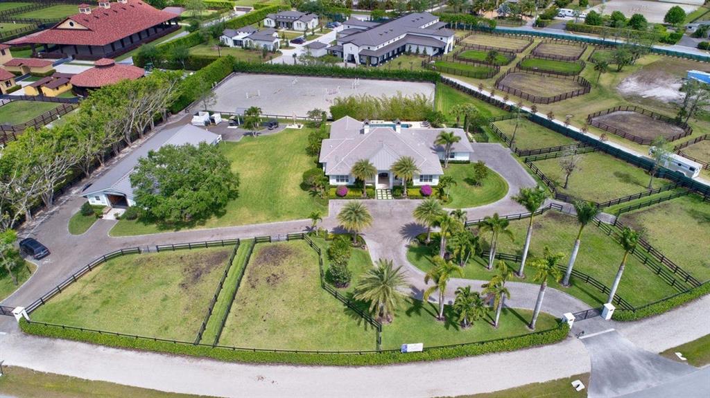 Less than a half mile hack to the Palm Beach International Equestrian Center and The Winter Equestrian Festival, this 2.46 acre farm has a 10-stall, CBS construction center aisle barn with feed and tack rooms, wash racks, and groom's apartment with full bathroom plus additional half bath, and full laundry facilities. Separate, gated entrances to the barn and house. 6 paddocks, dog run, sand ring (200' x 110' approx). The entire property – house, barn, ring and site work were totally renovated in 2016. The home features high end finishes such as impact glass windows, electric patio screens, tile throughout, home surveillance system. New pool, city water (well water irrigation system). Plans and permits in place for additional 2 bed/2 bath guest house and storage.