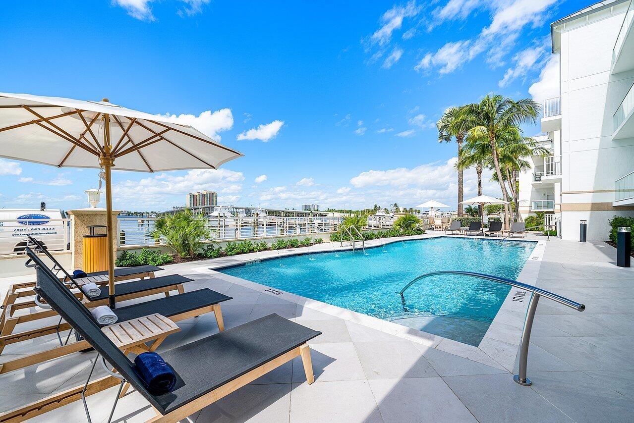 Luxury marina-front living in Palm Beach Shores at HAVN Residences & Yacht Club. Residence 2103 is a beautifully proportioned 3-bedroom, 3.5-bath waterfront residence offering private elevator entry, 2 garage parking spaces, and 2,606 interior square feet in one of the area's most exclusive boutique Intracoastal communities. Designed for a higher level of coastal living, this spacious Residence C floor plan features an expansive great room, oversized chef's kitchen with large island, quartz surfaces, premium appliances, wet bar, walk-in closets, generous storage, impact glass, and an expansive covered balcony with marina and Intracoastal views. The private primary suite lives like a retreat, while the secondary bedroom suites offer comfort and flexibility for guests, or a home office. What makes HAVN so special is the lifestyle. HAVN offers a private waterfront setting with just 36 luxury residences and a full-service 52-slip marina, with priority slip availability for owners, resident day dock, resort-style pool and hot tub, fitness center, waterfront fire pit, outdoor kitchen, beach access and services, courtesy bicycles, paddleboards, kayaks, and a 6-passenger chauffeured golf cart for quick trips around town. For boaters, this location is especially compelling with marina access, no fixed bridges, and quick access to the Palm Beach Inlet and open water.  Palm Beach Shores is one of South Florida's most charming waterfront towns, tucked between the Atlantic Ocean, Palm Beach Inlet, and the Intracoastal Waterway. Just moments from the beach, Peanut Island, Phil Foster Park, Sailfish Marina, shopping, dining, fishing, diving, and everyday waterfront activity, 2103 offers a rare opportunity to own a more spacious, luxury yacht-club-style residence in a setting that feels both relaxed and exclusive.