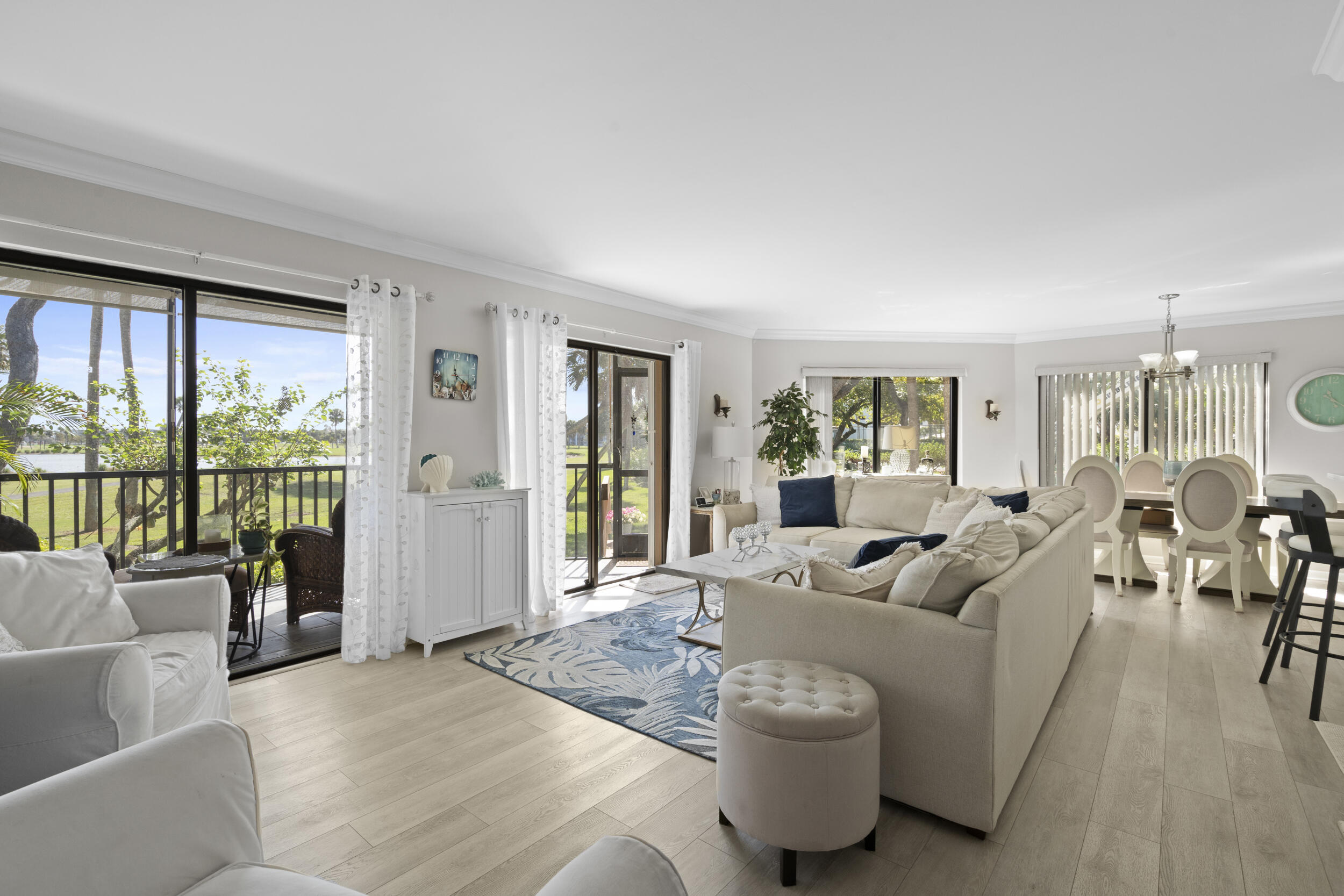 Properties like this rarely come on the market! This spacious 2-bedroom, 2-bath corner unit offers the convenience of first-floor living with wide open space and and layout that feels comfortable and inviting, steps to the tennis court and heated pool. Enjoy peaceful views of the pond and golf course right from your screen porch creating the perfect backdrop to relax. Across the street to the river to enjoy the beautiful sunsets. The kitchen features elegant quartz countertops and opens to the living area, making it ideal for entertaining or simply enjoying the spacious design. Both bedrooms are generously sized, offering comfort and privacy, while the well-maintained community provides a wonderful lifestyle just minutes from the beach. Now is the time to own your piece of paradise.