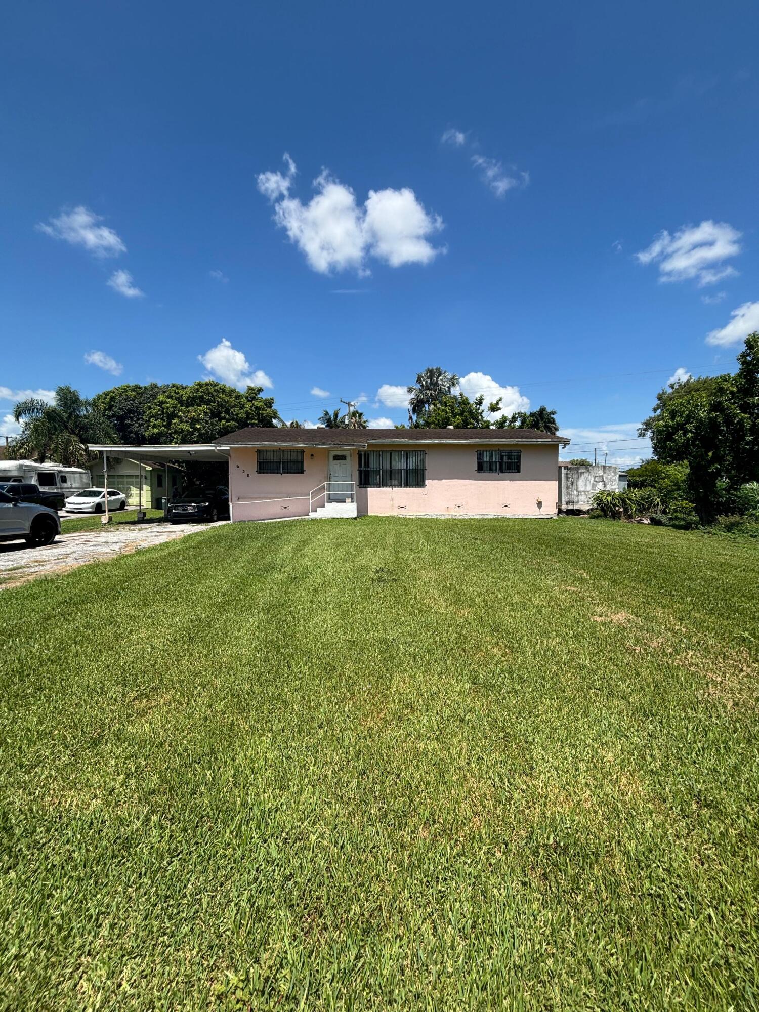 Welcome home to this charming 3-bedroom, 2-bathroom residence located in the heart of Belle Glade. Featuring an open-concept floor plan, this home offers a bright and inviting living space perfect for both everyday living and entertaining. The spacious bedrooms provide comfort and flexibility for families of all sizes, while the included washer and dryer add convenience and value. Step outside to a large backyard with plenty of room for gatherings, barbecues, and outdoor activities. Whether you're hosting guests or enjoying quality time with family, this expansive outdoor space is sure to impress. Conveniently located near local schools, shopping, dining, and major roadways, this property offers the perfect combination of comfort, space, and accessibility.