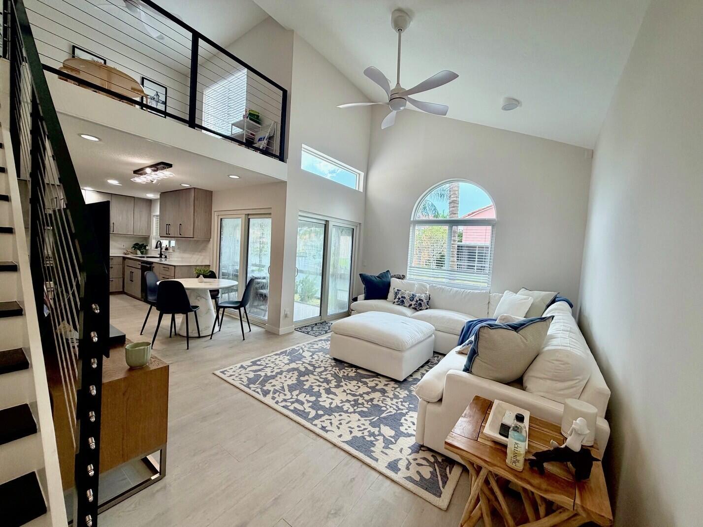 PROFESSIONAL SHOOT COMING SOON- A truly unique offering, this turnkey, extensively upgraded lakefront residence captures breathtaking daily sunsets and offers the rare opportunity to enjoy elegant waterfront living less than one mile from South Florida's wide sandy beaches. Located within the prestigious gated, pet-friendly community of Homes at Sheridan, this exceptional home is ideally positioned in one of South Florida's most naturally preserved coastal settings, surrounded by protected preserve land with expansive Intracoastal views. Thoughtfully redesigned with sophisticated finishes throughout, this custom residence features a spacious first-floor primary suite with an oversized custom closet and built-in dresser system. Dramatic living spaces showcase soaring vaulted ceilings, an   architecturally striking modern staircase, and a loft-style second bedroom that can easily be converted back to its original configuration. Abundant natural light is enhanced by stunning designer lighting, creating a warm and inviting ambiance throughout.  The showpiece kitchen boasts premium quartzite countertops, custom cabinetry, and Frigidaire Professional Series appliances (2024). Additional upgrades include porcelain plank flooring throughout, impact windows and doors (2021), and a tile roof (2019). Residents enjoy resort-style amenities including a clubhouse, pool, fitness center, sports courts, gated entry, and professional management. Ideally located just 1-1.5 miles from John U. Lloyd Beach State Park, Hollywood Beach Broadwalk, marinas, waterfront dining, shopping, and entertainment. Dania Beach continues to experience exciting multimillion-dollar redevelopment and investment through its ongoing CRA initiatives.