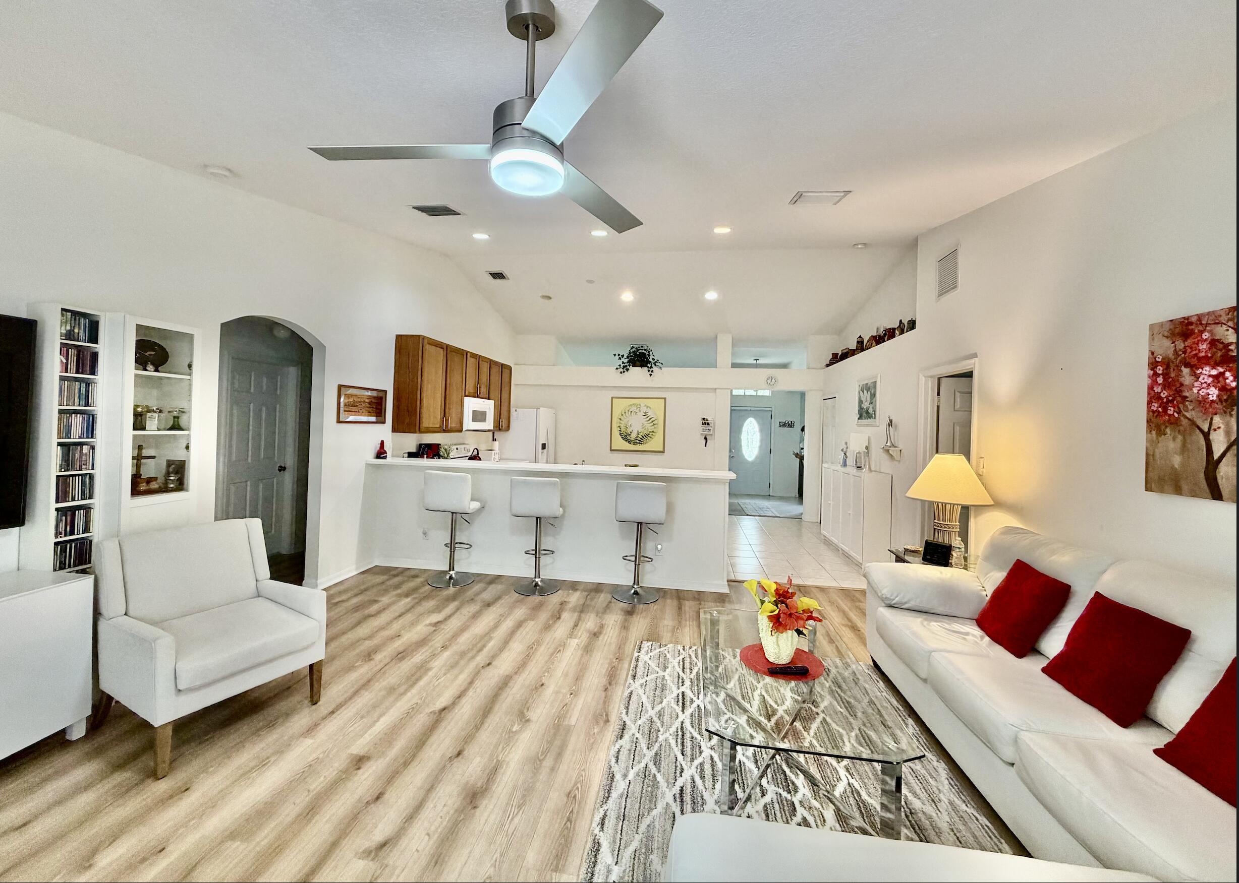 Welcome to this spacious single-story residence in Palm Lakes Gardens, Fort Pierce, offering 2,131 square feet of comfortable living space. This four-bedroom, two-bathroom home provides ample room for various lifestyle needs, whether you're seeking a place to grow or looking for efficient use of space. Natural light illuminates all rooms.  Open concept living ideal for entertaining. The new screened in patio enhances the natural outdoor beauty. The two-car garage adds convenient parking and storage solutions. Situated in an established gated community, the home offers a tranquil living environment, walkable trails and natural beauty offering a retreat from the outside world.  Furniture is negotiable.  Brand new roof June 2026.