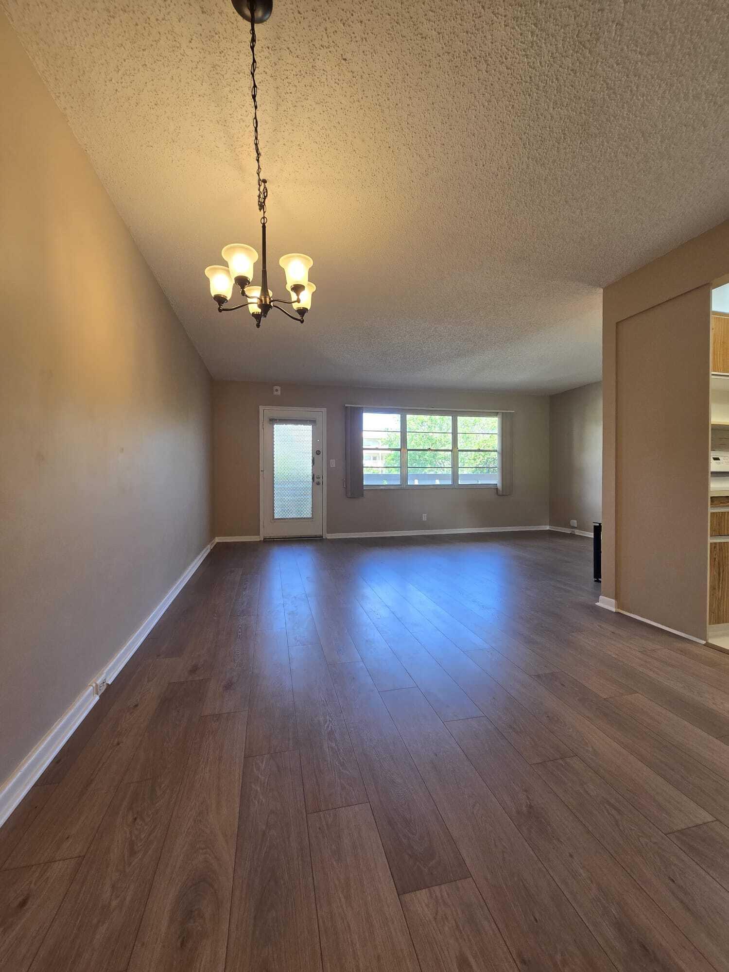 1BR/1.5BA Condo in Wynmoor Community (55+) move-in ready 1-bedroom, 1.5-bath residence featuring brand-new flooring throughout and fresh interior paint. Bright and spacious layout with excellent flow and abundant natural light. Enjoy peaceful garden views that create a relaxing, private atmosphere. The kitchen is generously sized, well maintained, and offers ample cabinetry and functionality. Comfortable living and dining areas enhance everyday living. Additionally, A/C replaced approximately 6 years ago, and a well-maintained water heater. Wynmoor Community, a gated 55+ resort-style community offering golf, pickleball, tennis, pools, fitness center, theater, shuttle service, and an active social lifestyle.