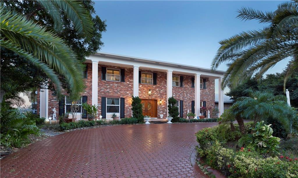 Giving the sense of an island oasis in the wondrous setting on Lake Sylvia, this dramatic deepwater point estate commands unsurpassed southeasterly views all the way down the water in a prestigious beachside enclave. The 136±-ft. shoreline has full-service dockage for a 116±-ft. luxury yacht. View-filled window walls open the Georgian-inspired residence to the outdoor entertainment space right by the water’s edge. The recently renovated gourmet kitchen opens to the bright family/breakfast room.