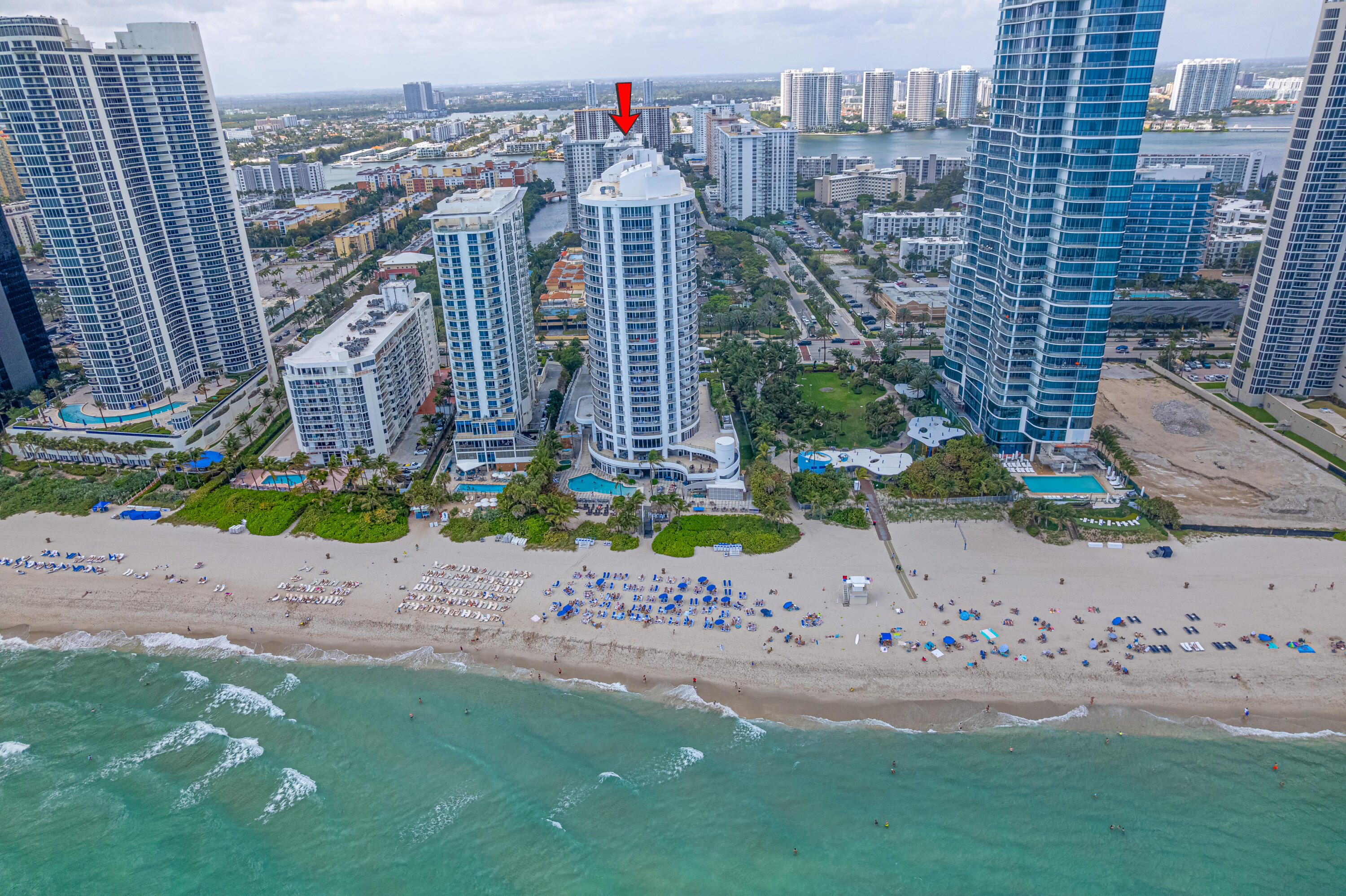 Spacious corner residence in the heart of prestigious Sunny Isles Beach, just a short 2-minute walk to the beach. This high-floor 2-bedroom, 2-bath unit offers approximately 1,840 sq ft of living space with stunning ocean and city views. The layout also includes a den that can easily be used as a third bedroom or home office. Enjoy a large wraparound balcony perfect for relaxing or entertaining, along with tiled flooring throughout. Maintenance includes water, internet, cable TV, sewer, and reserves. The building offers excellent amenities including 24-hour security, swimming pool, fitness center, sauna, and billiard/game room. Ideally located near Aventura Mall, Bal Harbour Shops, Gulfstream Park & Casino, as well as supermarkets, restaurants, pharmacies, and more.  Located within an A-rated K-8 school district. Enjoy the Sunny Isles lifestyle—your chance to live in paradise!