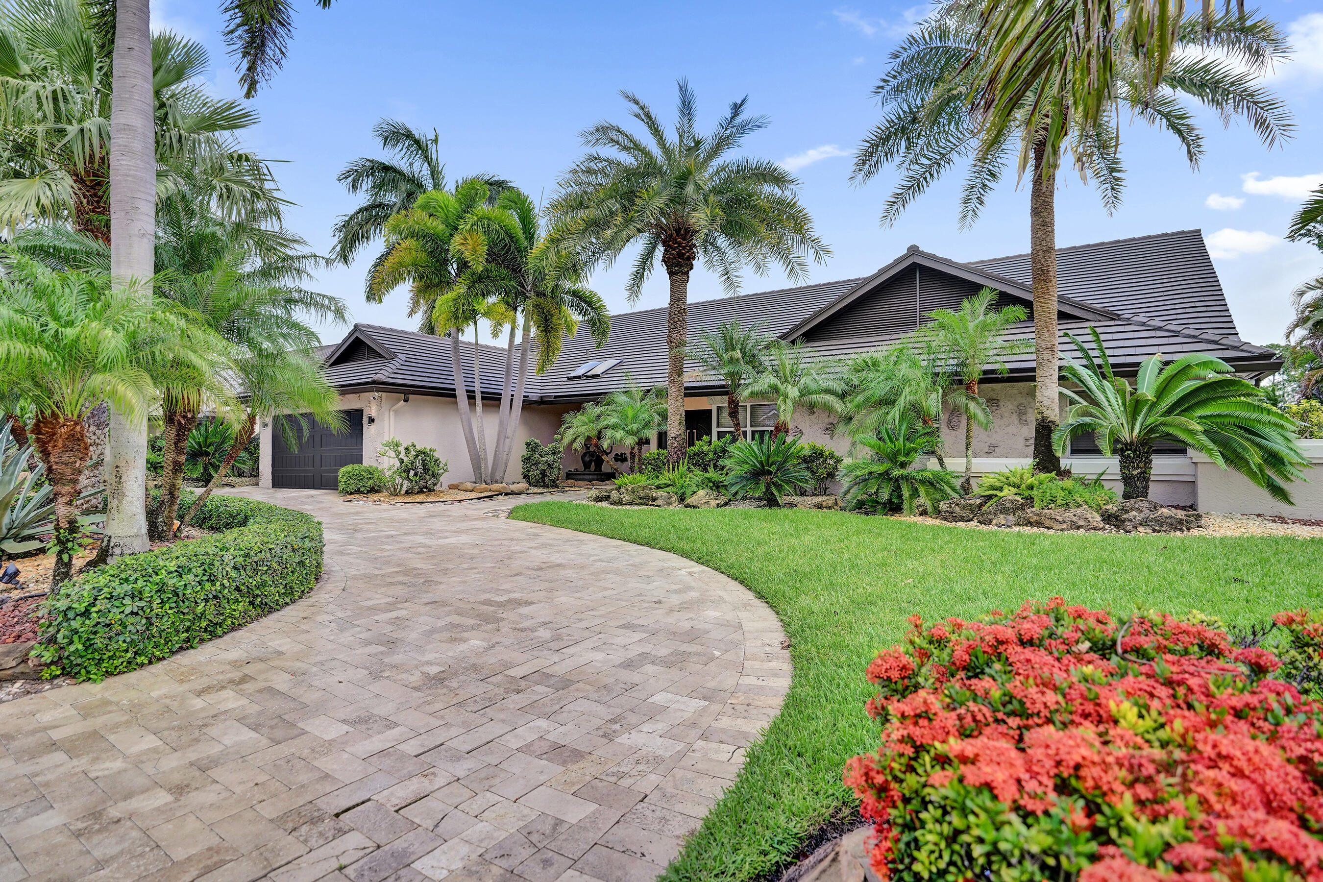 Welcome to one of Boca Raton's most sought-after gated golf course communities Boca Woods. This beautifully updated luxury pool home offers the perfect blend of elegance, comfort, and resort-style living, ideally positioned on the golf course with serene fairway views, exceptional privacy, and seamless indoor-outdoor living. The heart of the home is a brand-new designer chef's kitchen, featuring a spacious island and peninsula, elegant granite countertops, custom wood cabinetry, and premium Fisher & Paykel appliances perfect for entertaining and everyday living. Designed with a highly desirable split bedroom floor plan, the home offers both privacy and functionality.  Additional highlights include a dedicated wine room, spacious laundry room, convenient dog wash station, and a newly installed A/C system for year-round comfort and efficiency. Step outside to your private backyard oasis, where a sparkling pool overlooks the lush golf course creating the ultimate setting for relaxing, entertaining, or enjoying Florida's year-round sunshine. Located in one of Boca Raton's premier golf communities, Boca Woods is renowned for its championship golf, country club lifestyle, gated security, and exceptional amenities. This move in ready home offers a rare opportunity to enjoy luxury living in one of South Florida's most desirable neighborhoods.