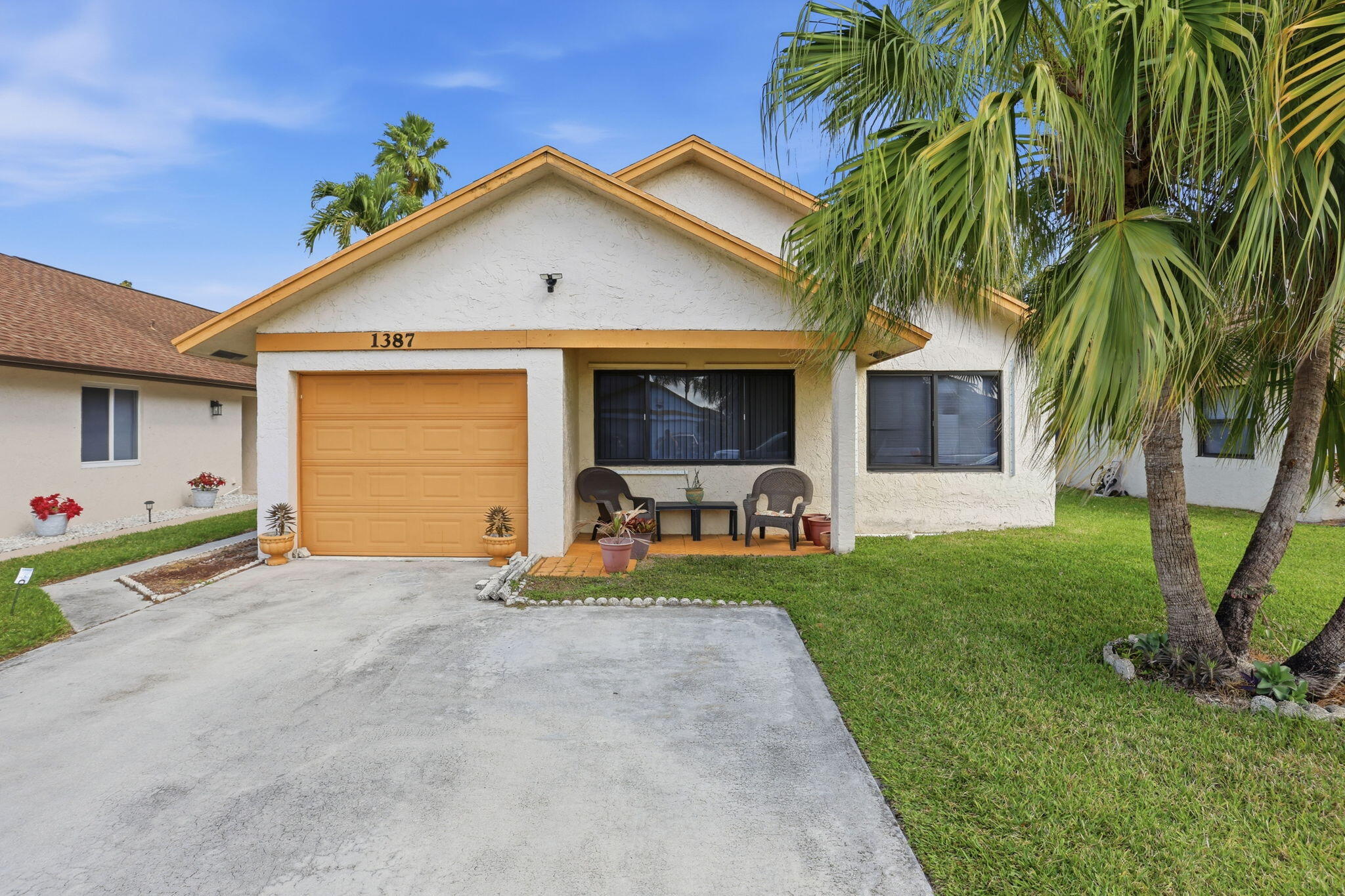 This 3 bedroom, 2 bathroom home with a 1-car garage has a bright, open feel the moment you walk in thanks to the high vaulted ceilings and large sliding glass doors that bring in tons of natural light.  The living and dining areas flow together nicely, making the space feel comfortable and easy to live in. The kitchen sits right off the main area so you can stay connected while cooking or entertaining. Tile floors run throughout the home which makes maintenance simple.  The primary bedroom is spacious and has its own sliding doors out to the backyard. Both additional bedrooms offer good flexibility for guests, family, or a home office.  Some of the big-ticket items have already been taken care of with a brand new A/C installed in 2025 and a water heater replaced in 2024.  The guest bathroom has also been recently updated, giving it a fresh feel. The roof was installed in 2004.  Out back you'll find a nice yard with room to relax, garden, or entertain.